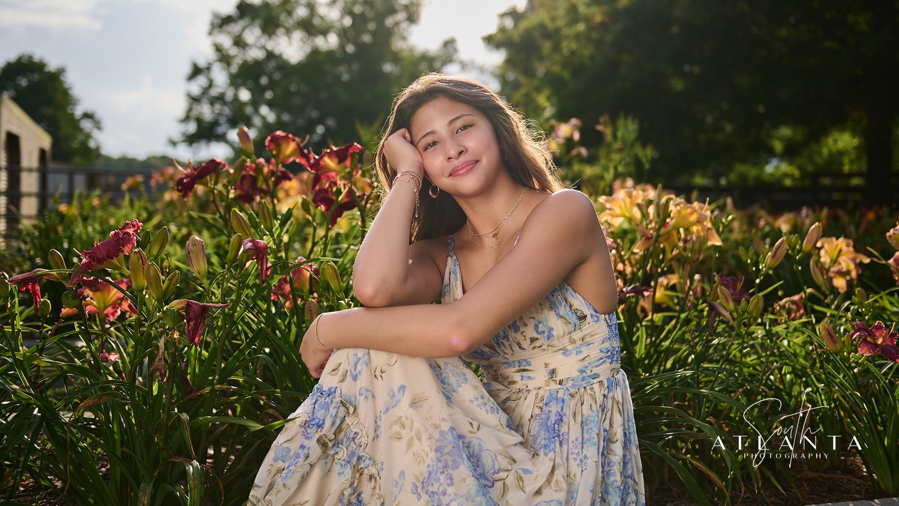 Natural senior portrait of a young woman seated among colorful wildflowers at Wild Daisy Farm during her Class of 2027 photo session.