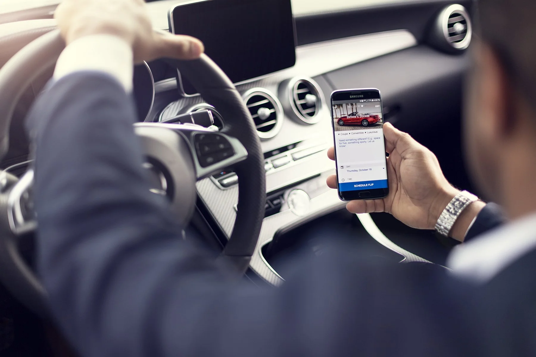 Commercial lifestyle photography featuring a Mercedes-Benz driver using a mobile device inside a luxury vehicle, photographed by South Atlanta Photography for an automotive marketing campaign
