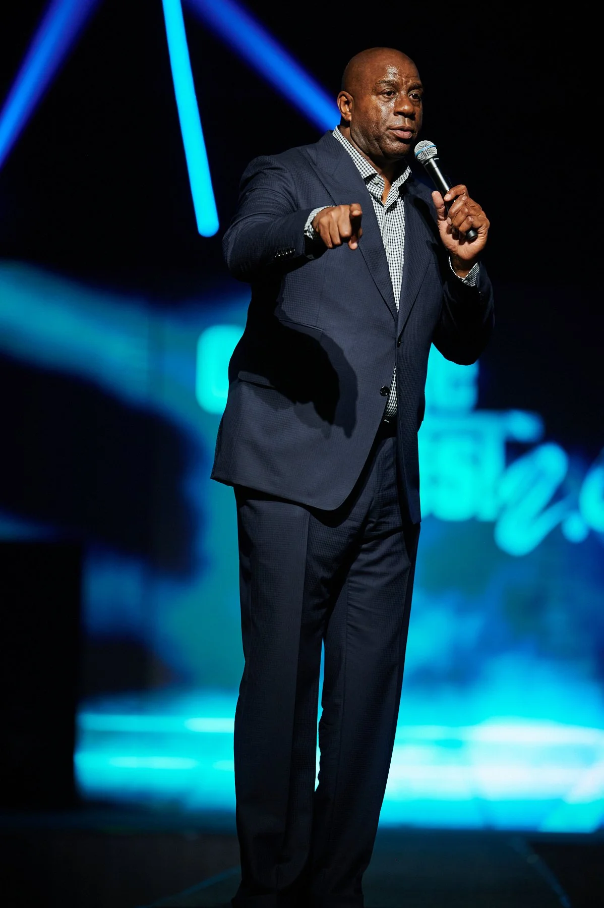 Magic Johnson keynote speaker addresses an audience onstage during a corporate conference photographed in Atlanta, Georgia.