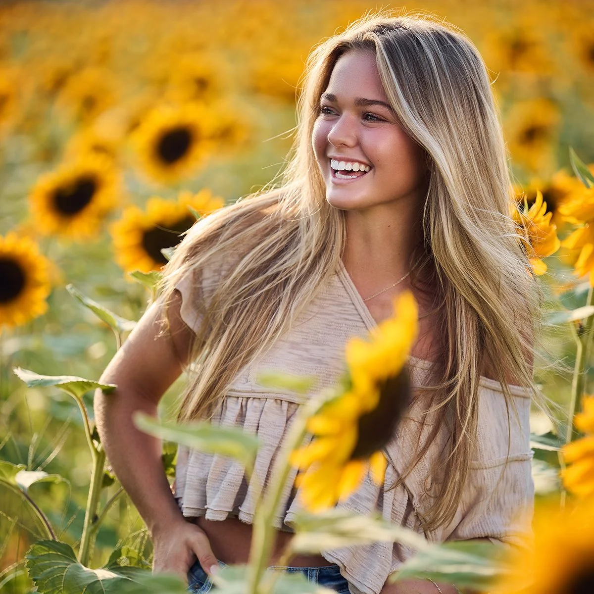 Girls senior portrait in a sunflower field at golden hour, photographed by South Atlanta Photography for Class of 2027 senior pictures in Peachtree City and Fayette County.