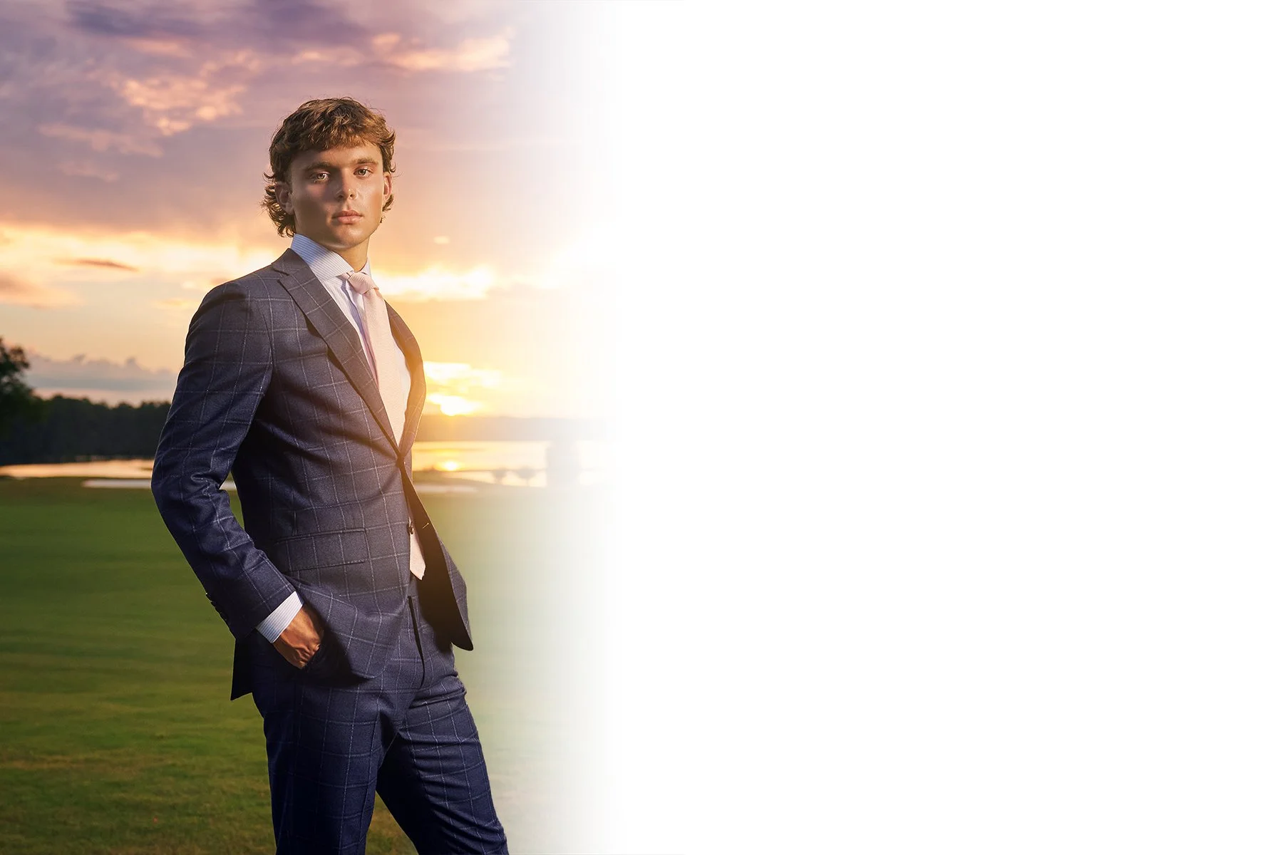 Class of 2027 senior portrait of a guy in a blue suit at sunset near Peachtree City, Georgia, photographed by South Atlanta Photography for boys senior sessions.