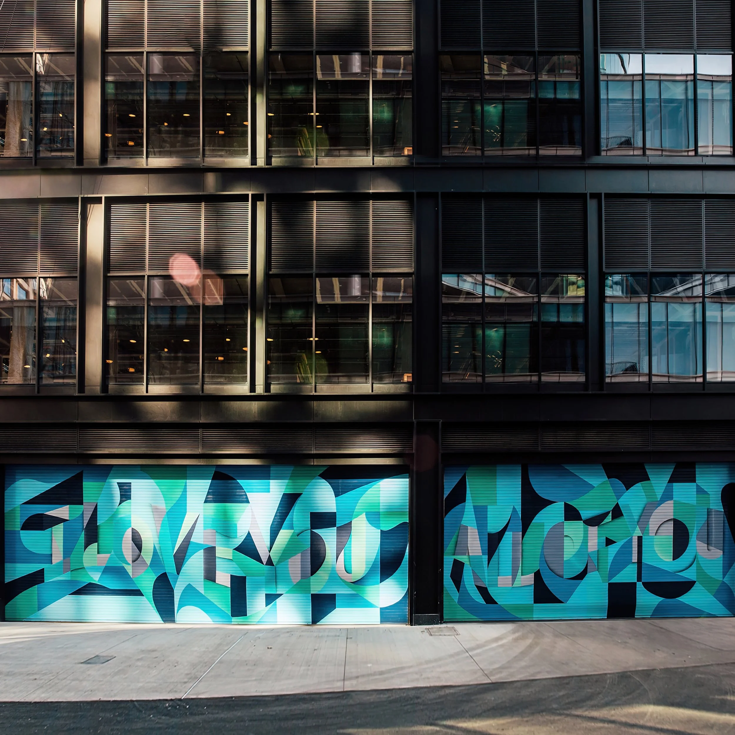 A colorful mural by artist Ryan Adams alongside the street of the Amazon Headquarters in Boston.