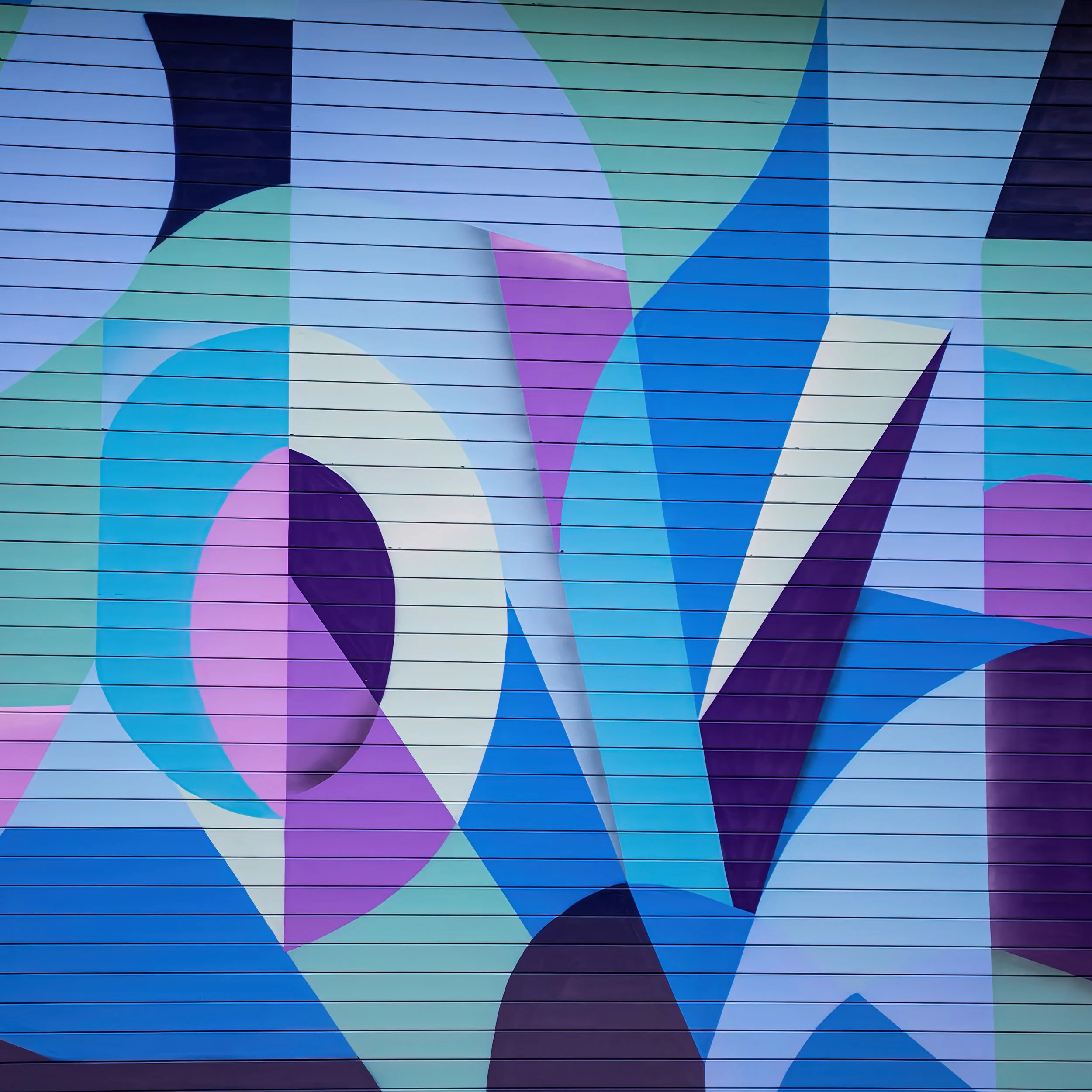 A detailed photo of the colorful mural by artist Ryan Adams alongside the street of the Amazon headquarters in Boston.