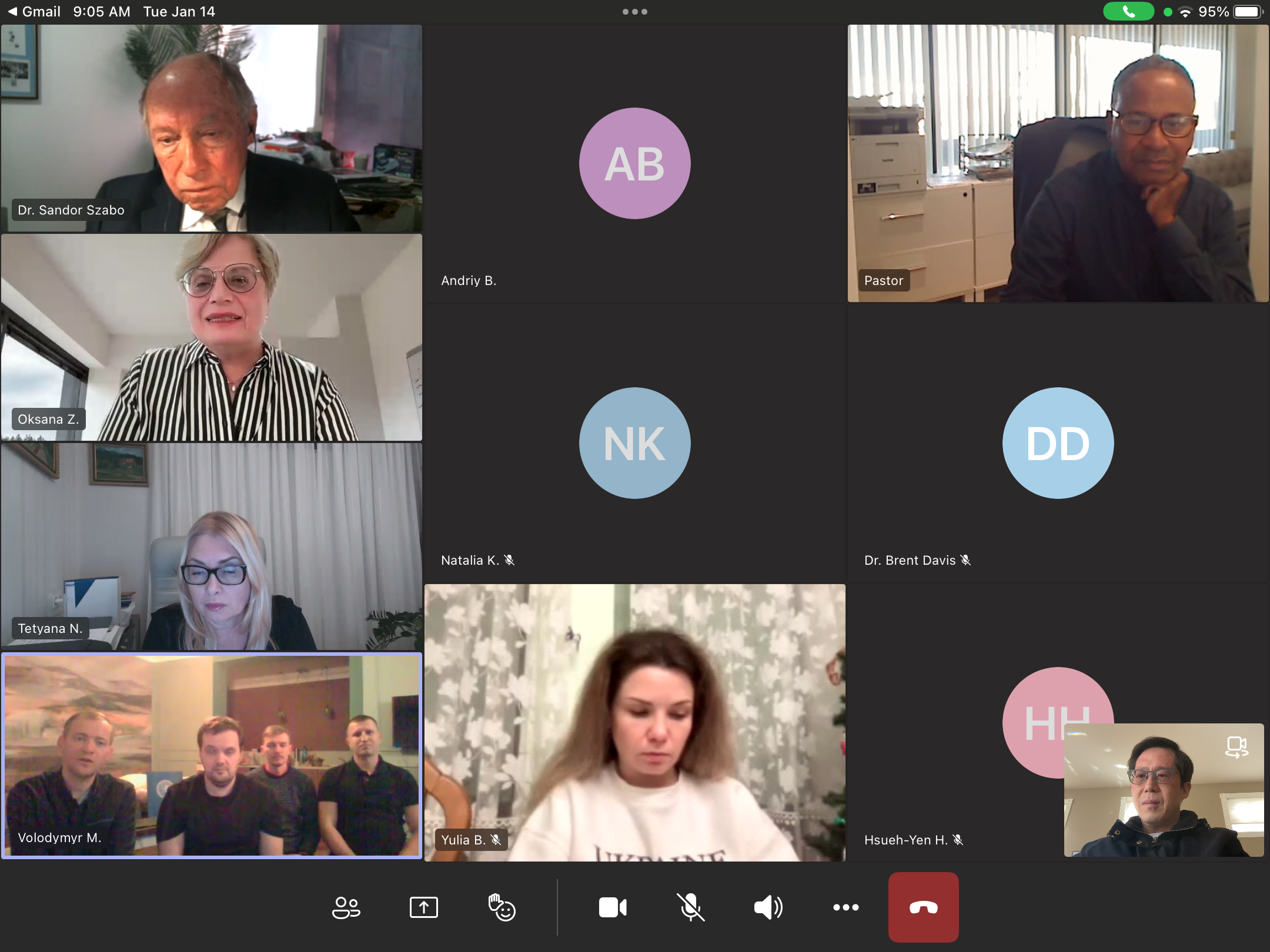 Screenshot of a virtual video conference with nine participants, including several with video on and a few with profile icons or muted microphones, in a grid layout.