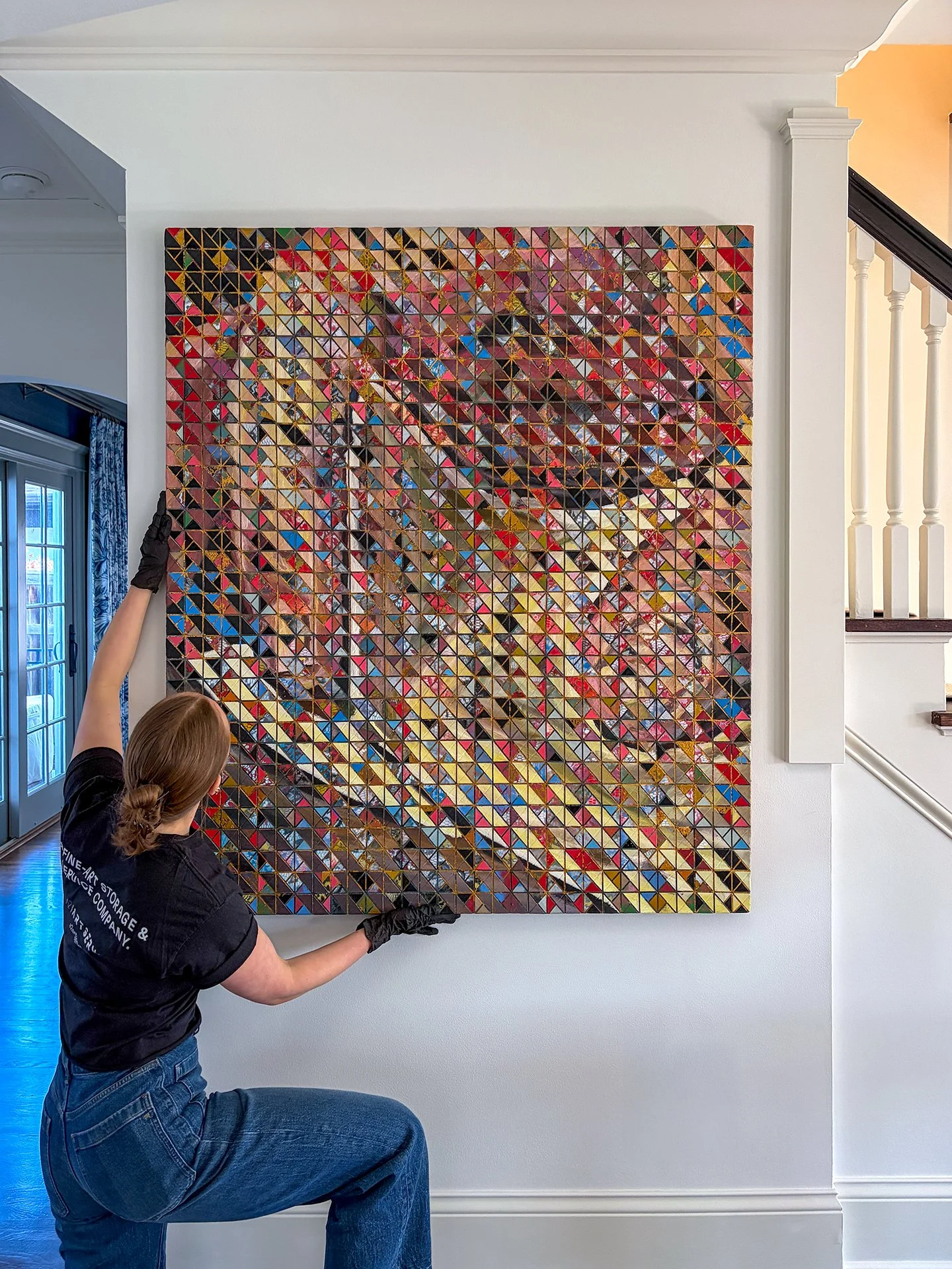 Artserve art handler technician installing fine artwork in home