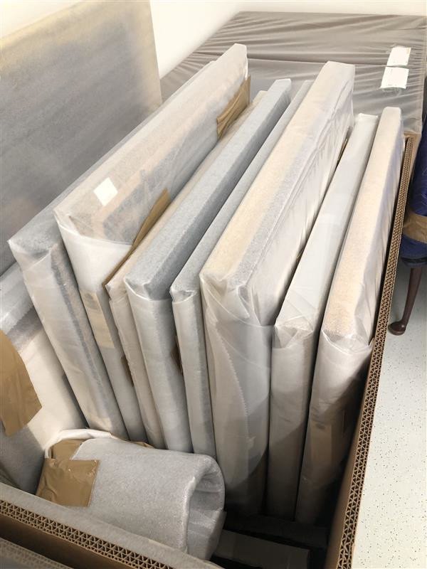 Commercial bin filled with fine art wrapped and packed by art handlers