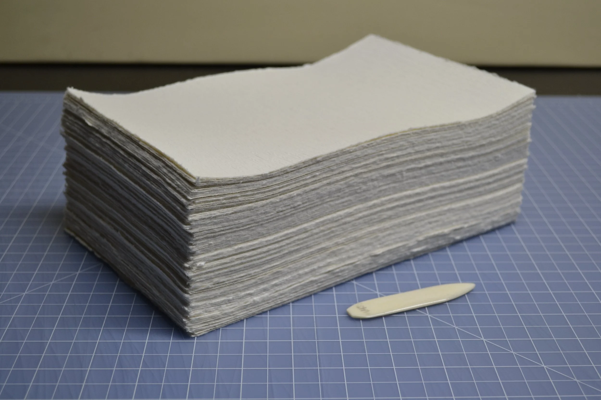 A thick stack of paper torn and ready to be folded