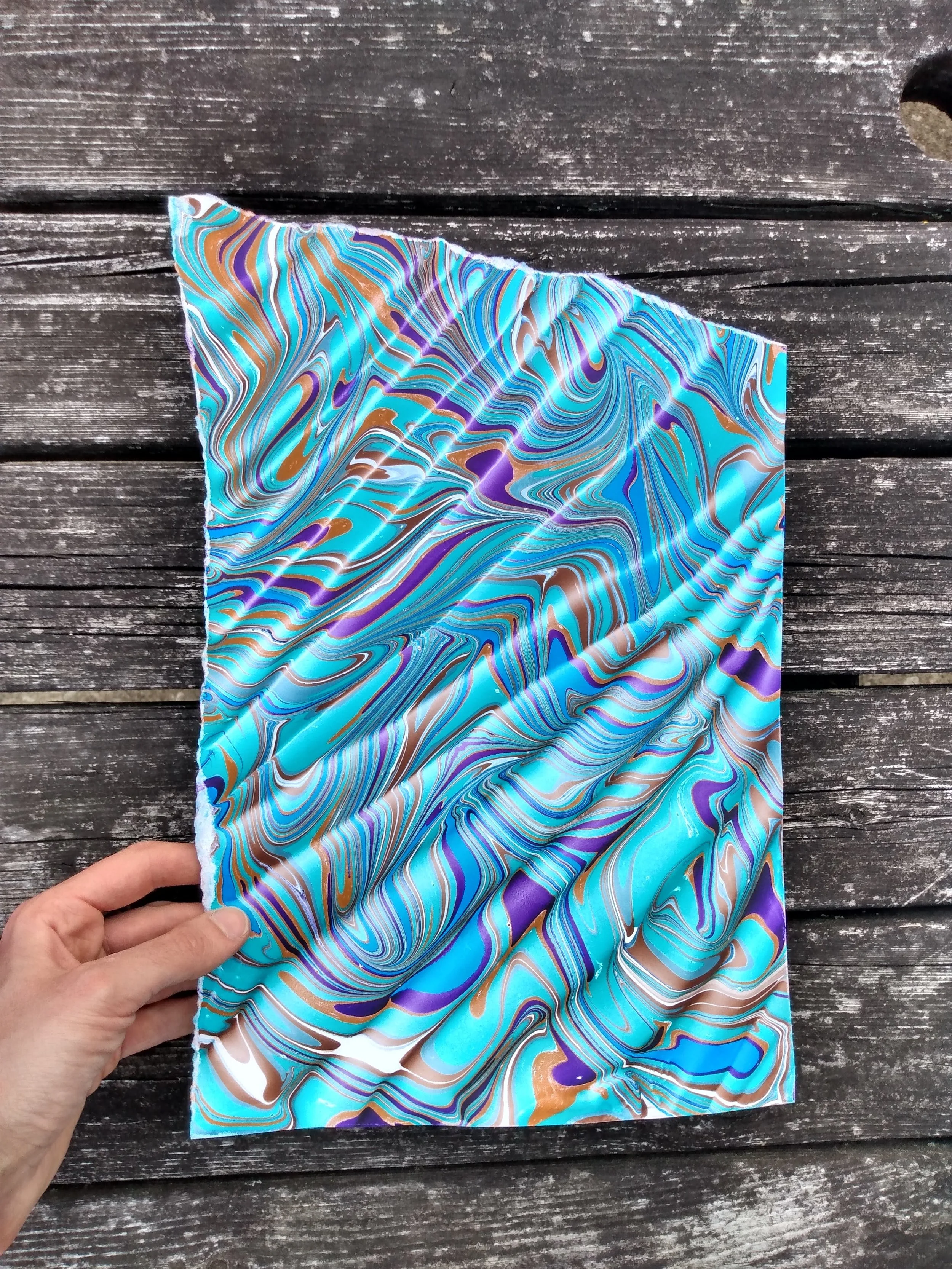 The old picnic table in the backyard became a great textured backdrop for marbled paper.