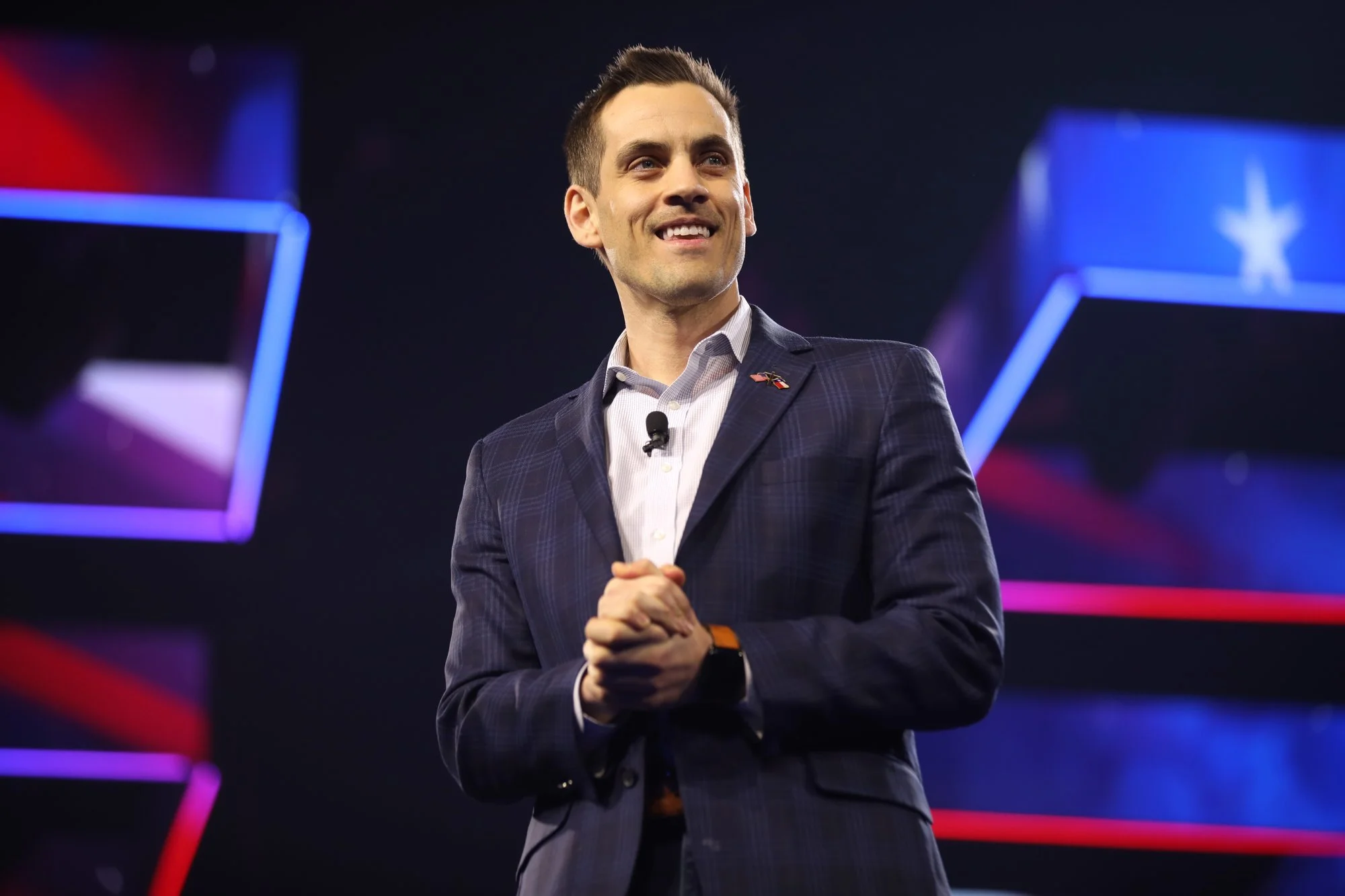 Christian Collins speaking on stage