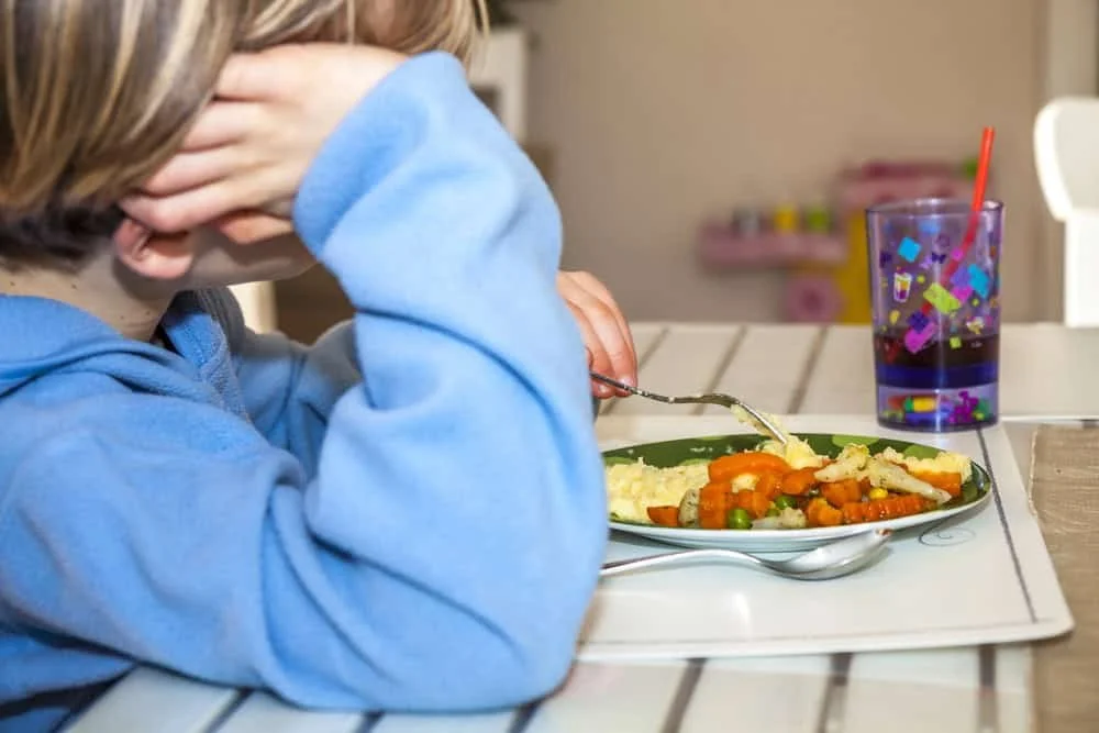 Male child, picky eater with fork and plate