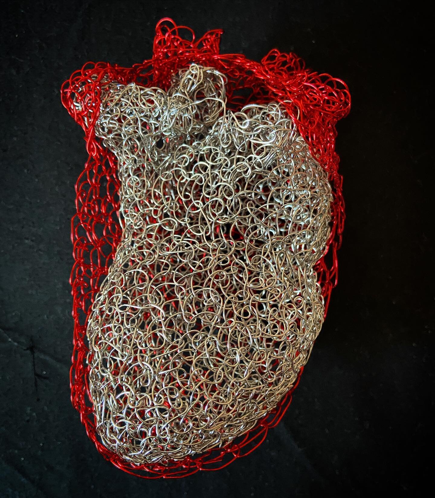 &lsquo;Heart-warming&rsquo; Mid-winter and mid-lockdown, stitching a cosy red wire wrap for a lonely steel heart feels like a good thing #WIP #wiresculpture #wireobject #smallsculpture #heart #maker #makersgunnamake