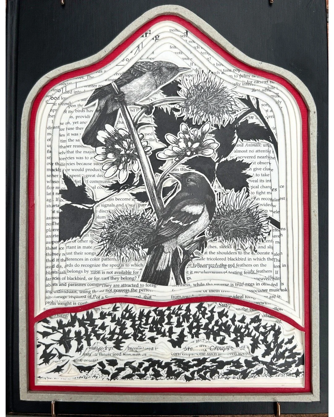 MELODY BUSH, Book Art by Melody , uses books to make art. This one is a book carving. She cuts a hole in the front cover and then cuts down into the book, to reveal what she wants you to see inside the book. 
Stop by the gallery and see what else she