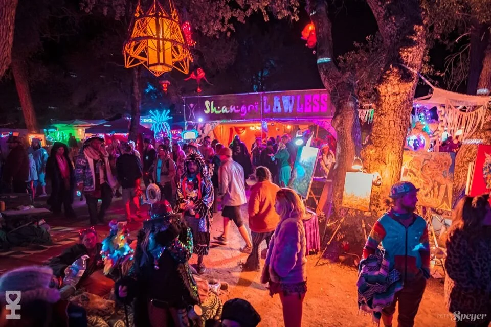 Participants enjoying one of the Burning Man theme camp installations “Shangri Lawless” and interactive live art.