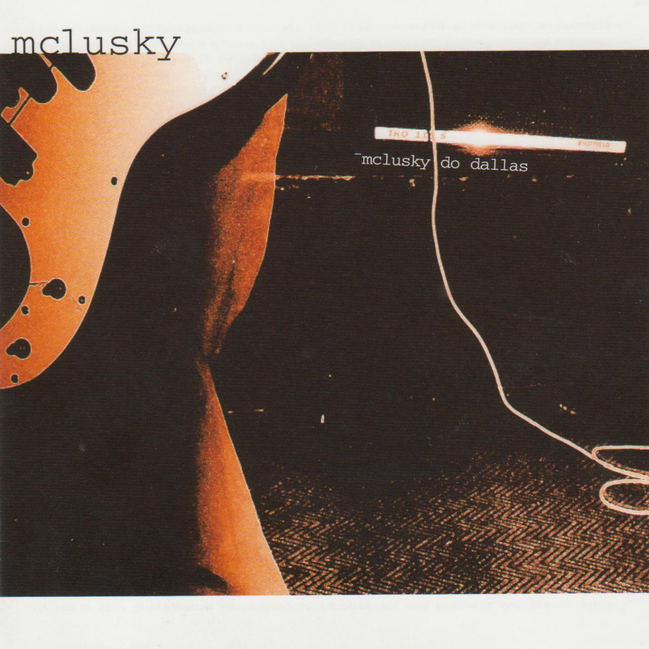 Cover art featuring an abstract, sepia-toned image of a guitar with the text "mclusky do dallas".
