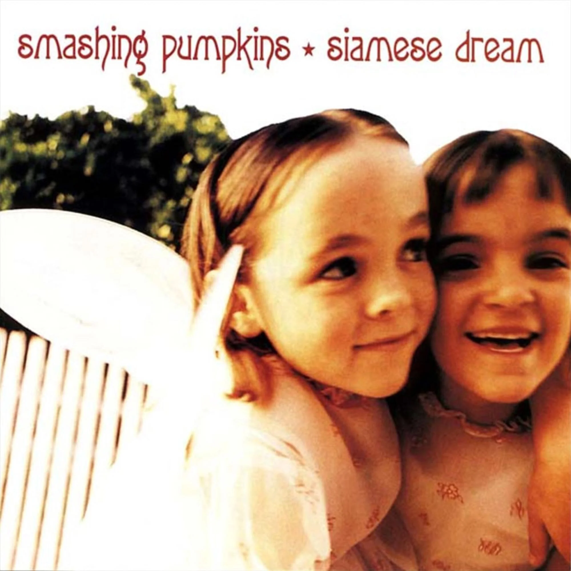 Album cover of "Siamese Dream" by Smashing Pumpkins, featuring two children embracing and smiling.