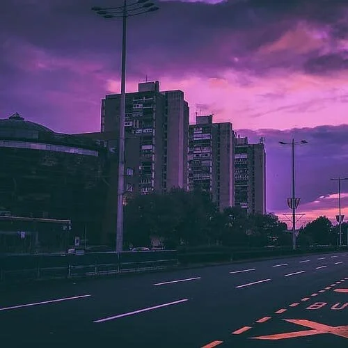 Urban skyline with residential buildings at dusk, purple sky