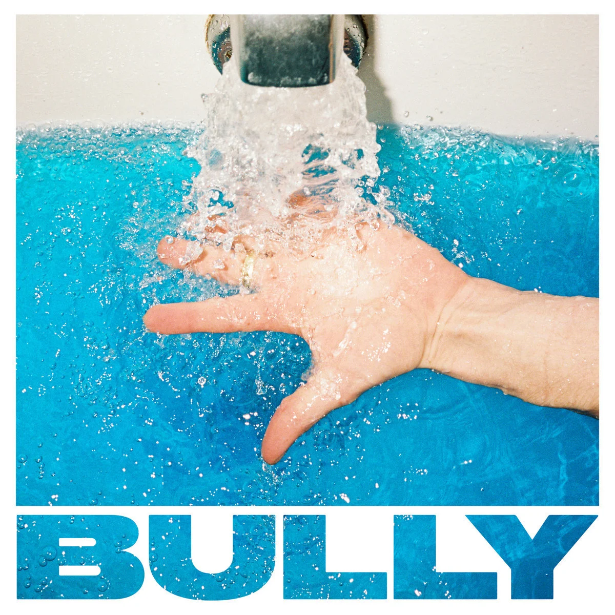 A hand under a running faucet with blue water and the word 'BULLY' in bold letters.