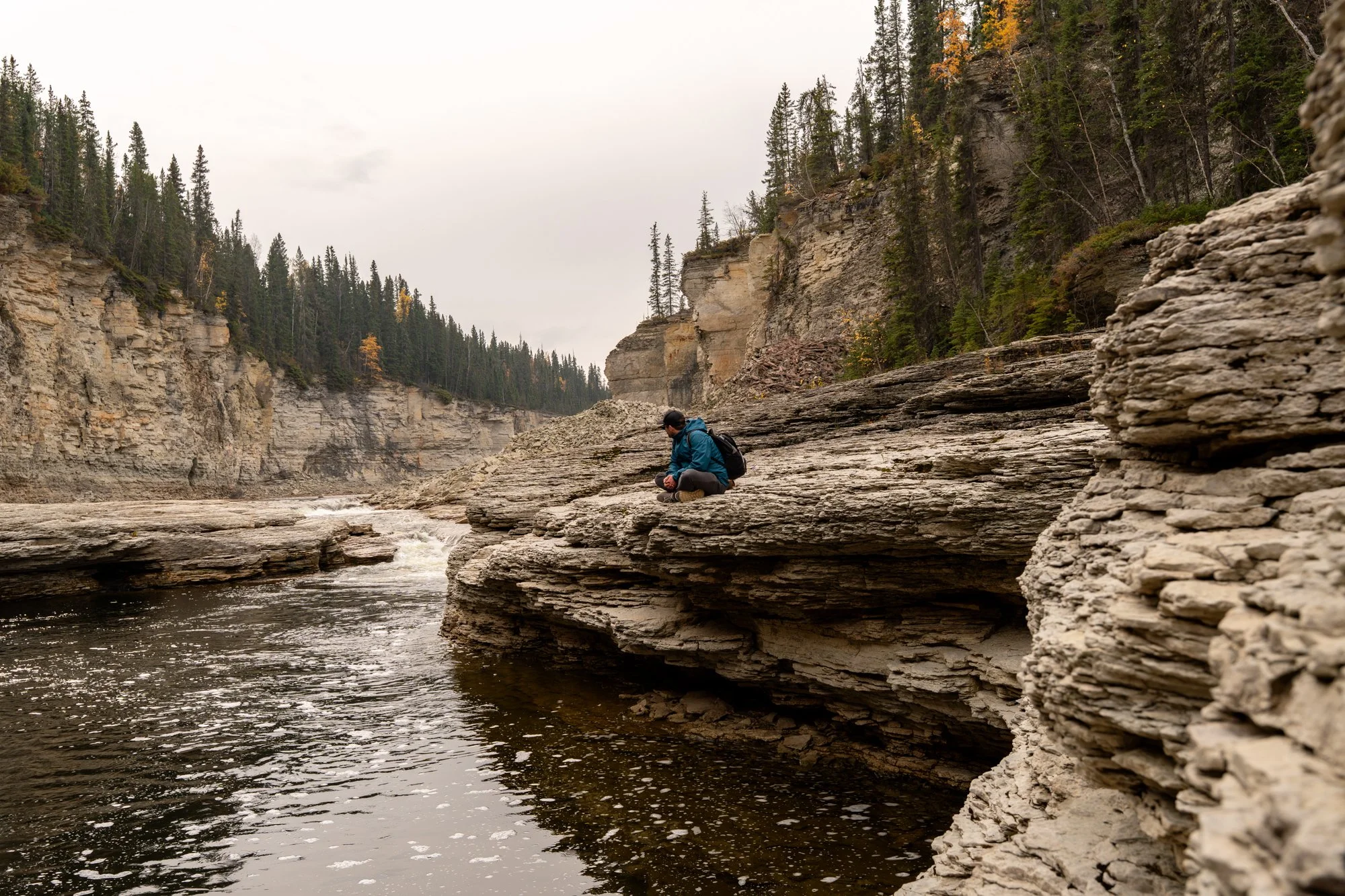 NWT-sombaa-deh-park-river-man-sitting.jpg