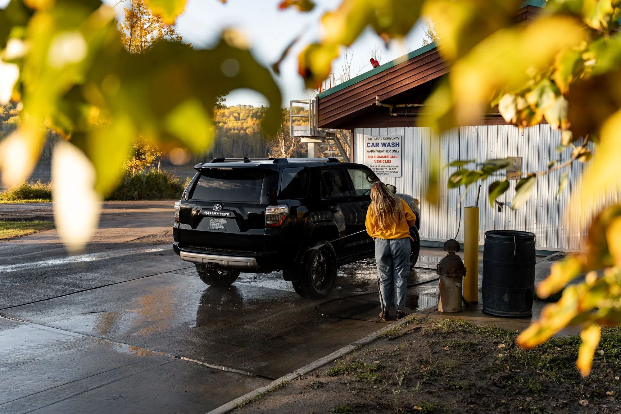 NWT-Fort-Liard-woman-washing-car-2.jpg