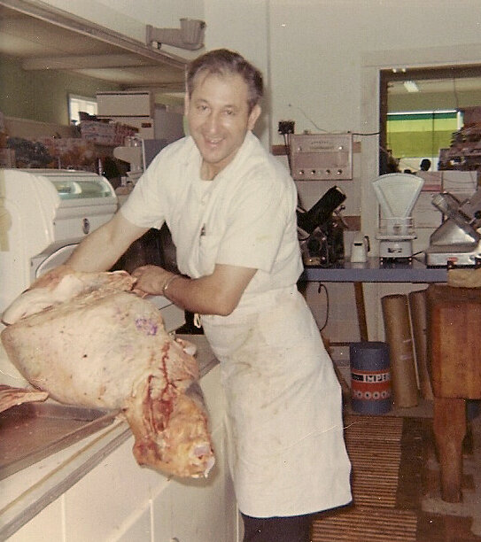 Bud busy at work in his butcher shop.