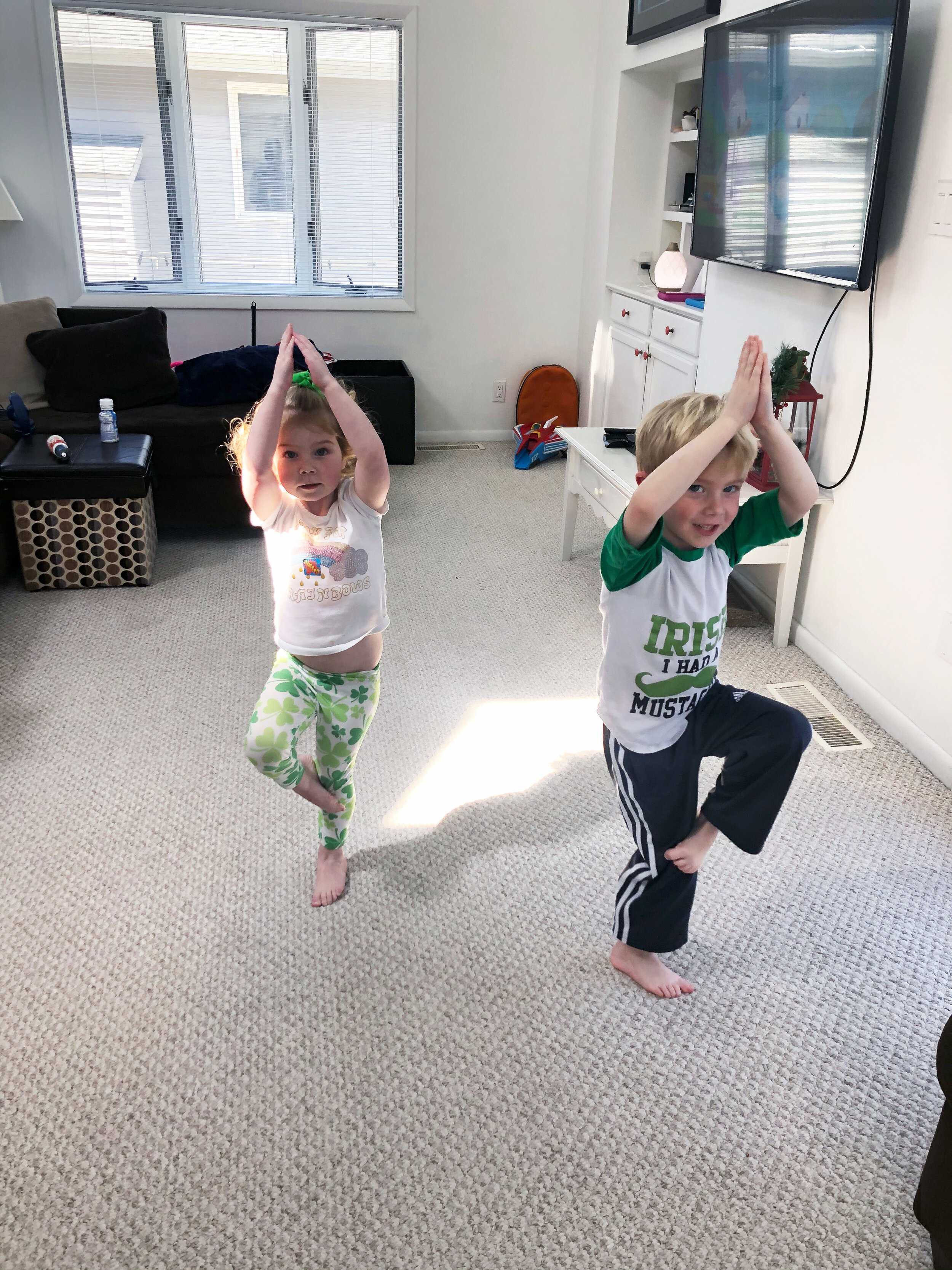 Emily and Declan practicing yoga poses.