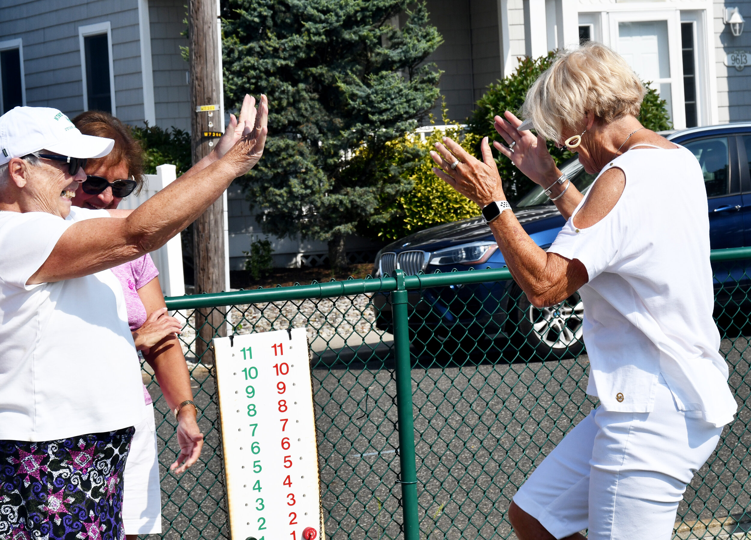 (right) Pam Talone (left) and Cathy Hammer celebrate a team win.
