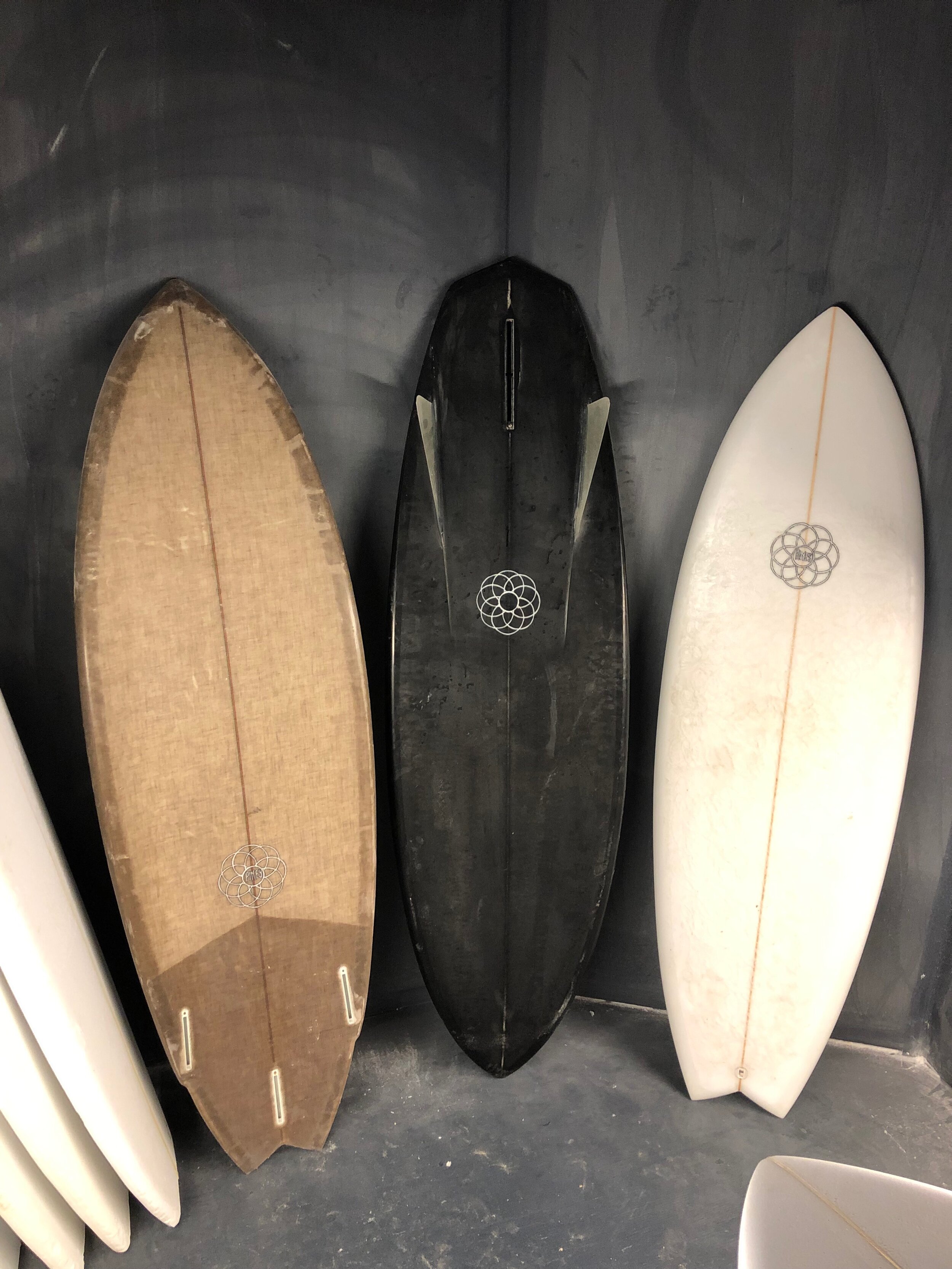 Some of Brian Carney’s creations include a board made with eco-friendly flax fiberglass and bio-based epoxy resin and a black-tinted bonzer with glassed-in twin fins. 