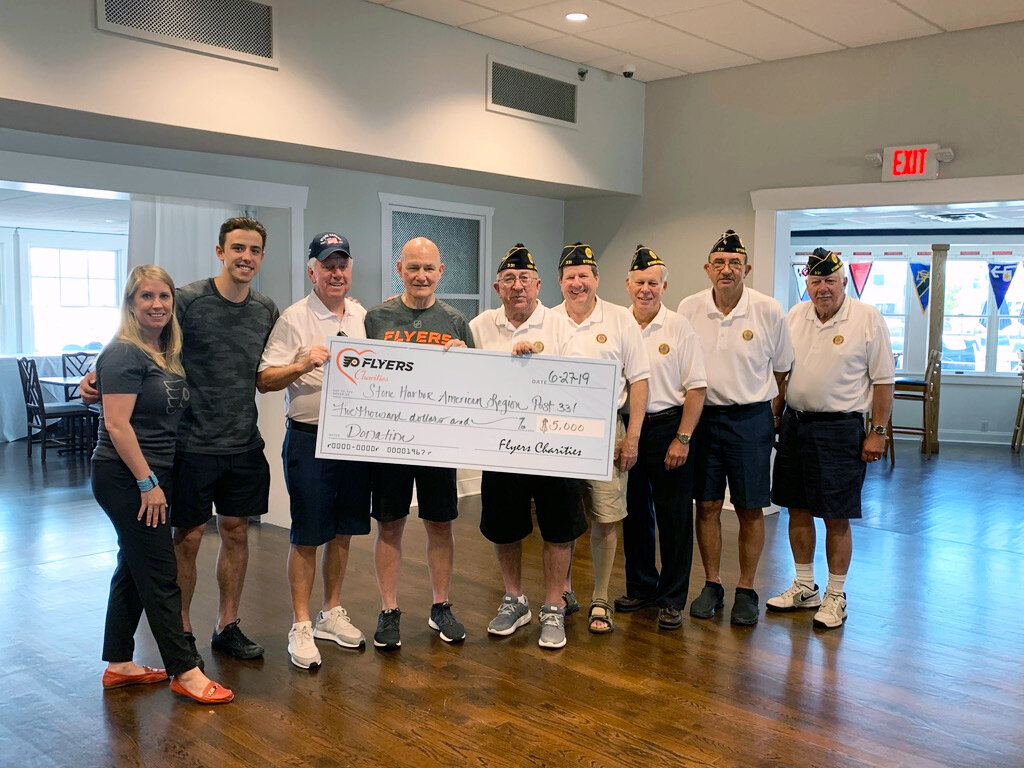 Representatives from Flyers Charities, Jim McCrossin, and members of American Legion Post 331 pose during the check presentation at the Yacht Club of Stone Harbor.