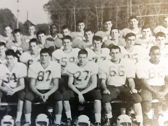 Bruce Land (27) poses with his high school football team.