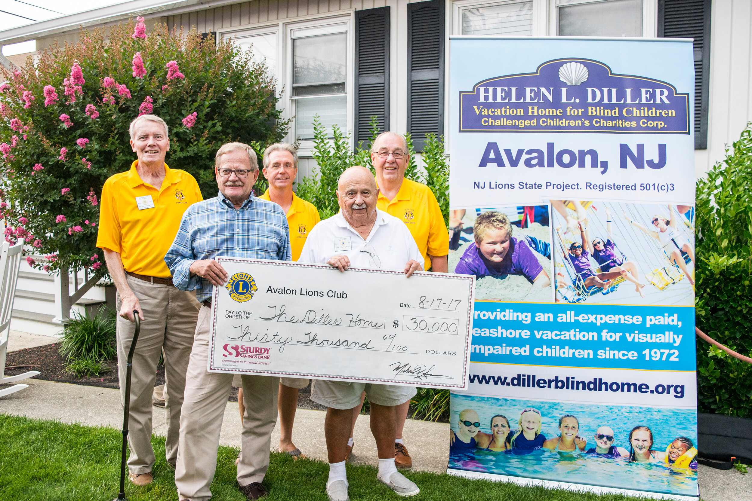 Avalon Lions Chuck Covington, Mike Sowers and John Molnar present a donation  to Helen L. Diller Vacation Home for Blind Children board members Doug Heun and Joe Ostrowski.
