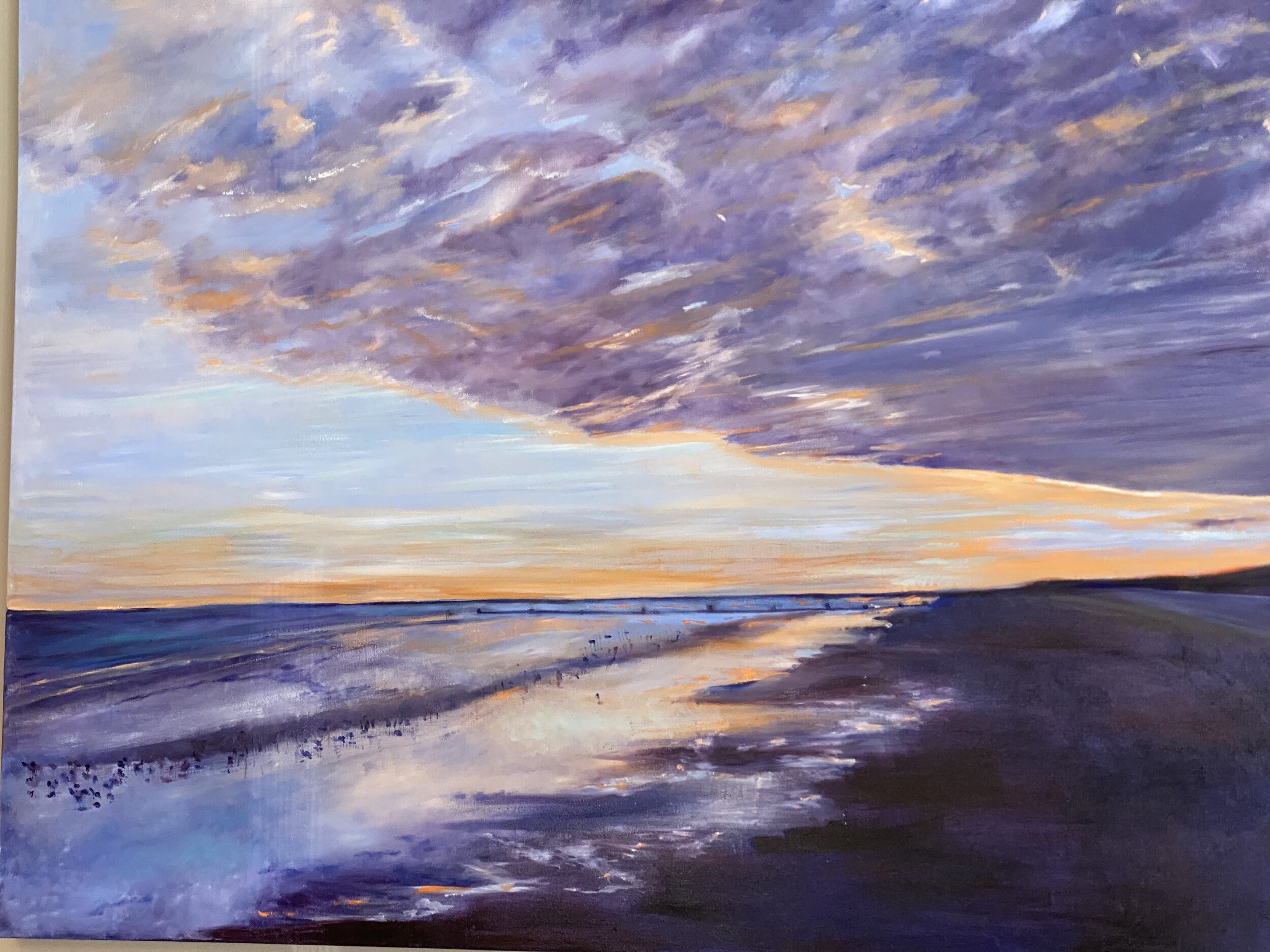 Neuman's painting of a Stone Harbor sunset on 122nd Street is displayed in the Hugh Merkle Team office.