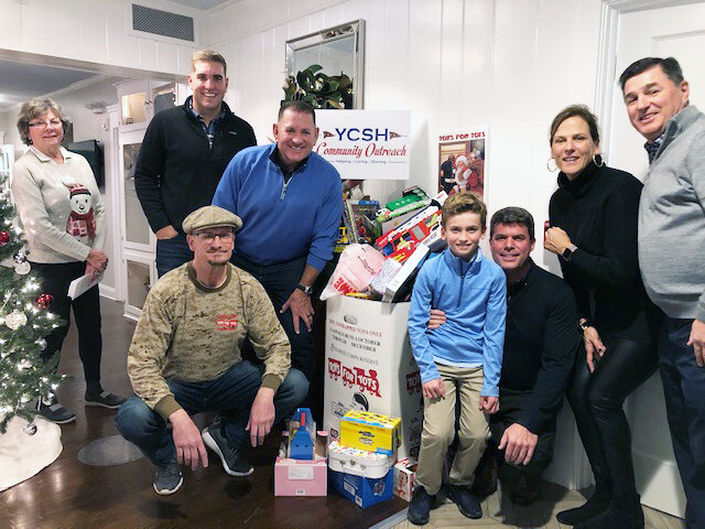 The Yacht Club also is active in toy and blood drives. Here are members posing with  Toys for Tots regional coordinator Kevin Mallon last year.