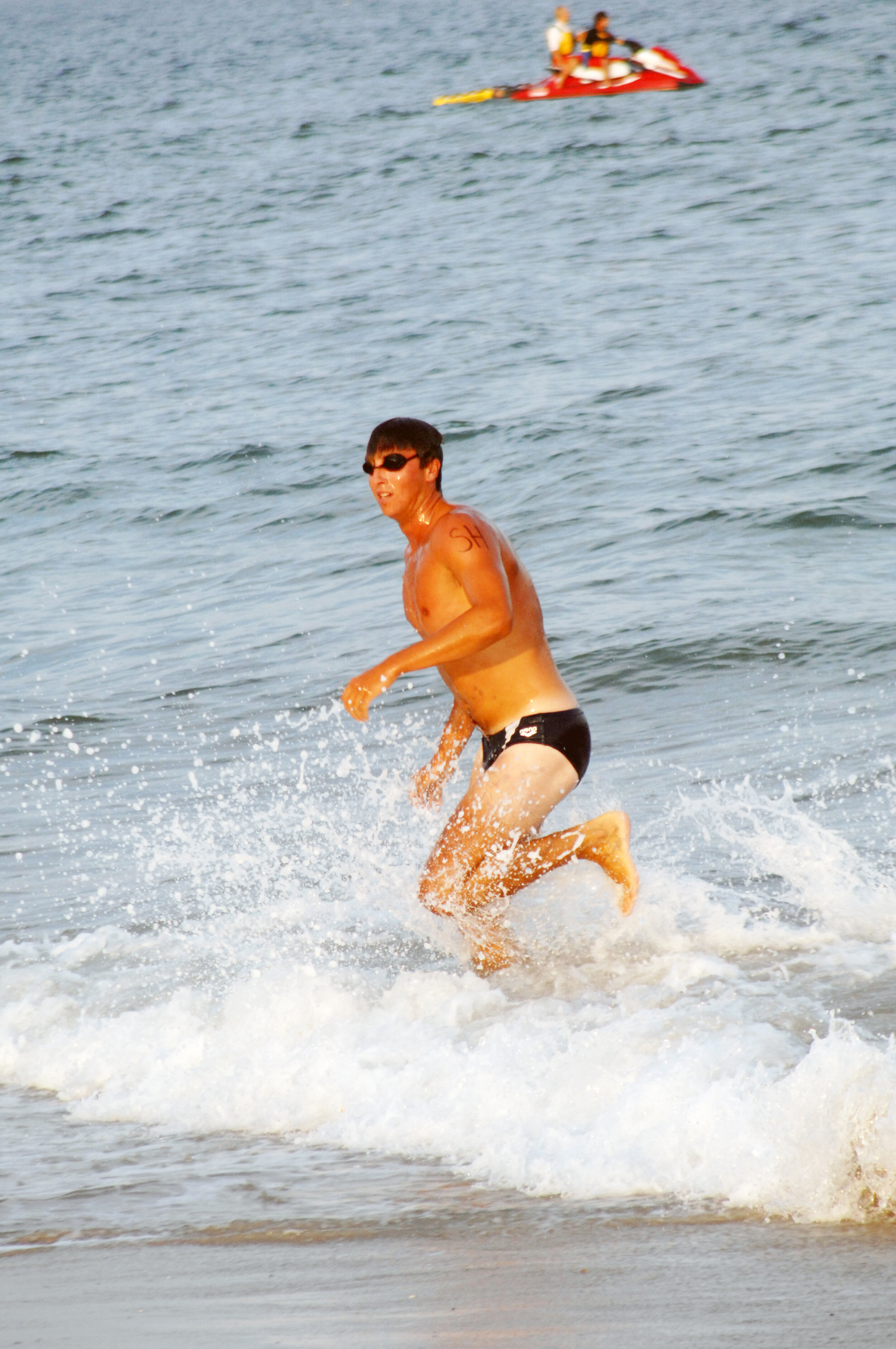 Justin McLellan runs into the water.
