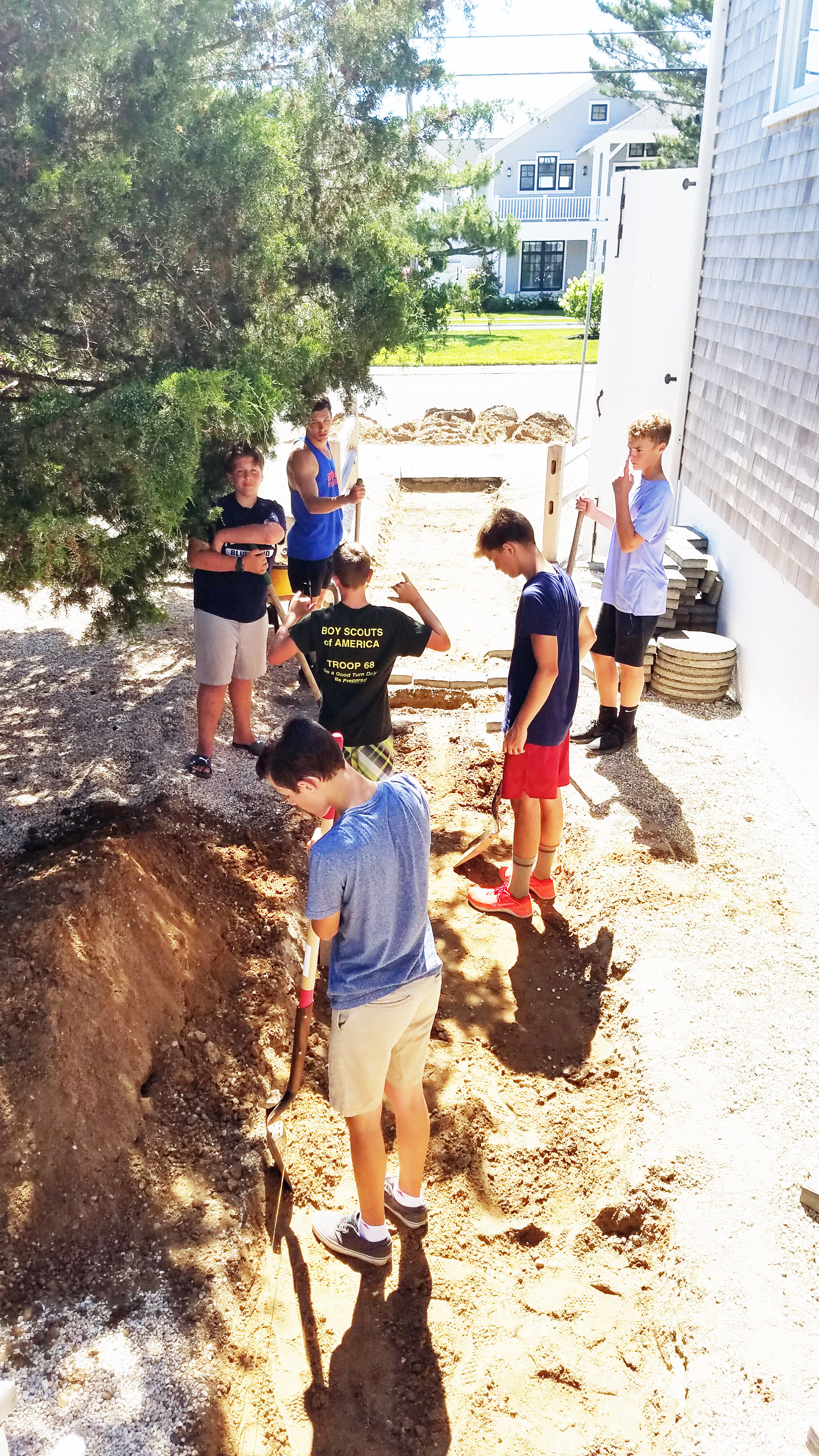 The boys clearing out area for new paver walkway.