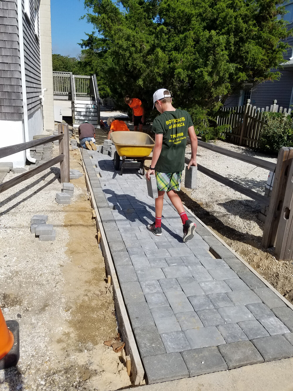 Bradley carts the pavers before completion.