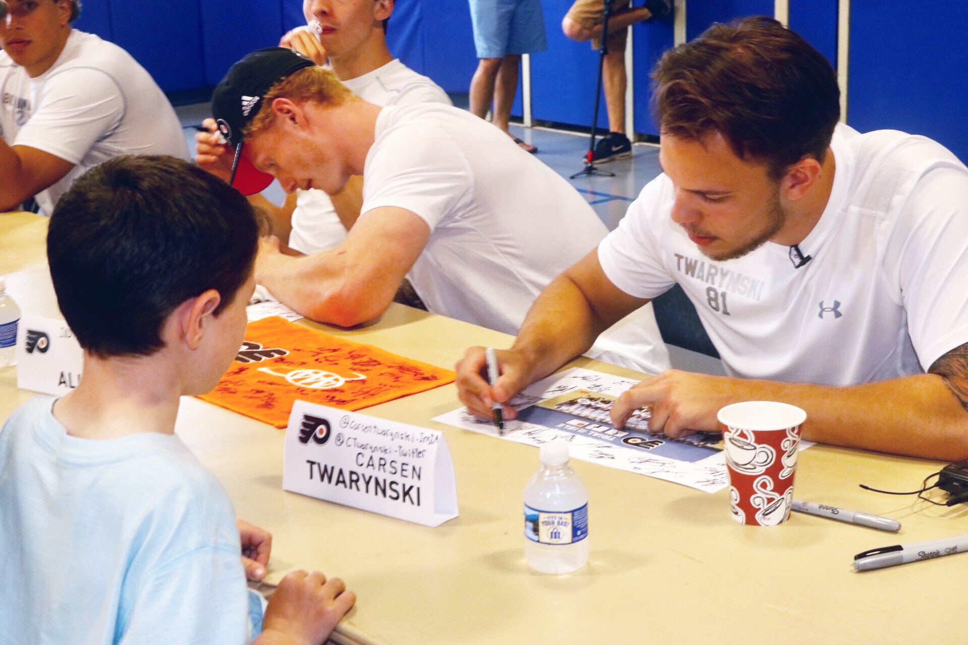 Declan Lawson getting poster signed by Carsen Twarynski.