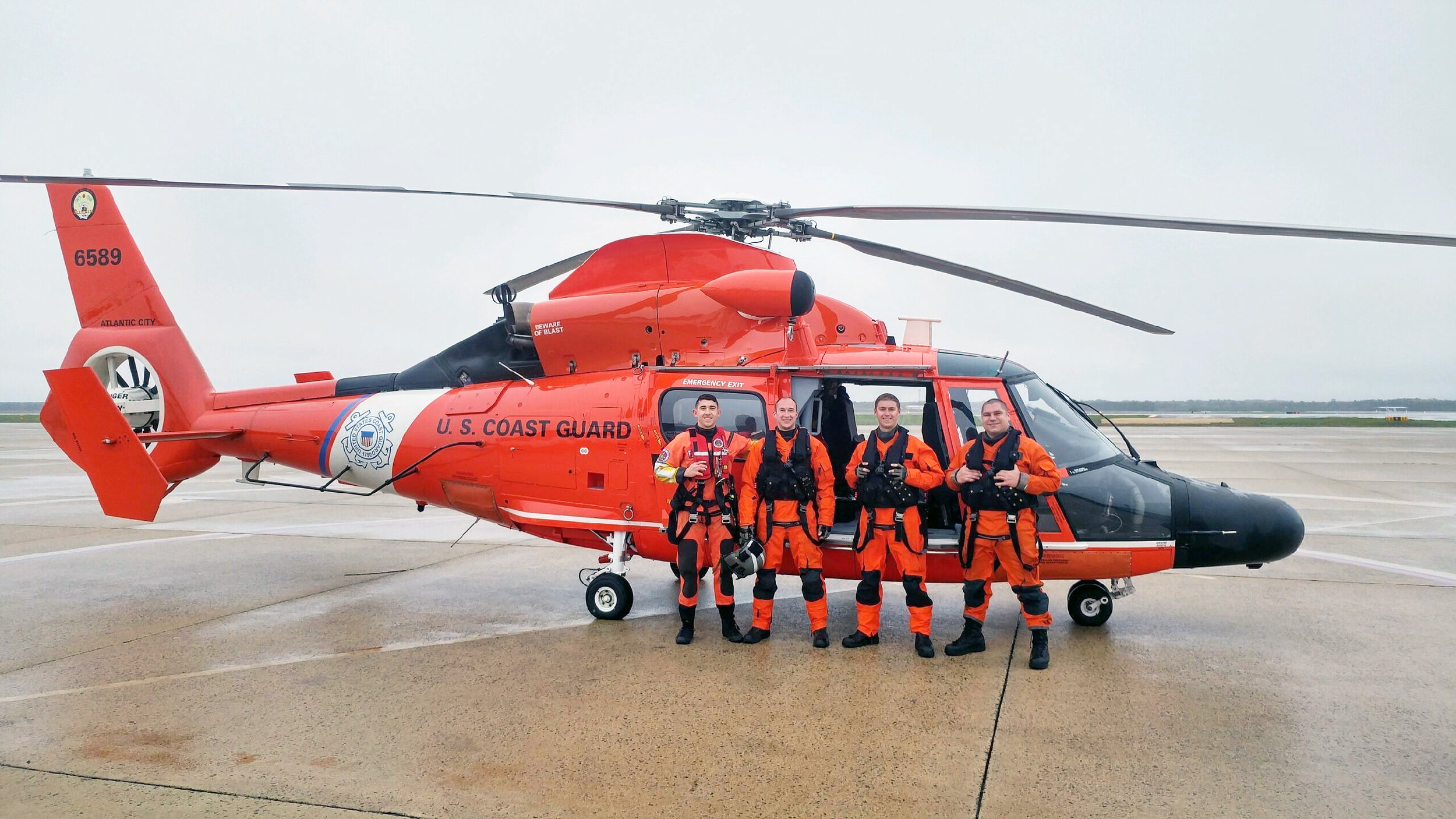  A Coast Guard helicopter crew poses for a group photo after a medevac mission in May 2016, when a 63-year-old fisherman fell ill aboard a 90-foot fishing vessel 60 miles southeast of Atlantic City. (U.S. Coast Guard photo) 