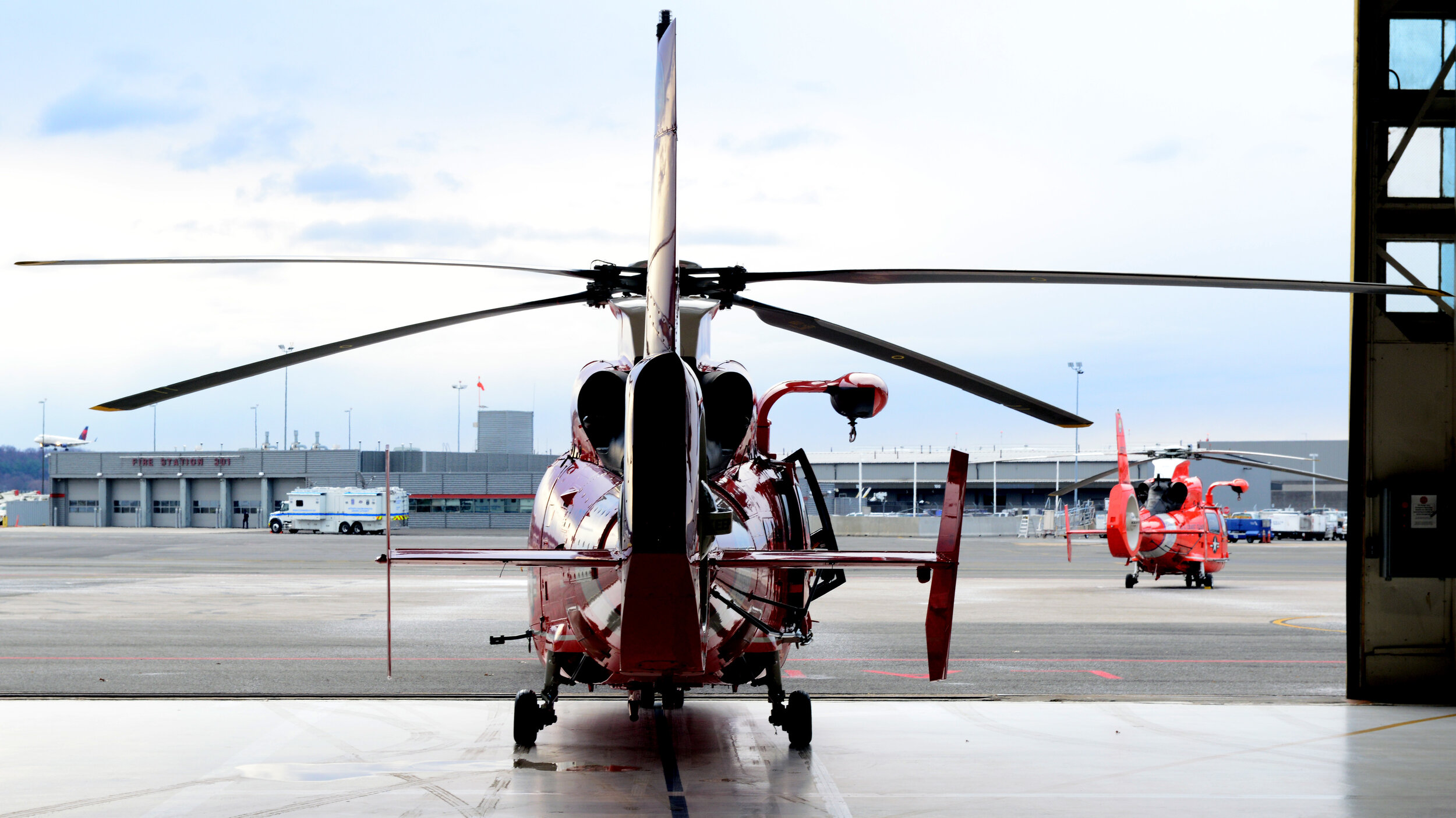  A Coast Guard MH-65 Dolphin helicopter taxis out of a hangar in Washington. Crews from Air Station Atlantic City support the National Capital Region Air Defense Facility by supplying multiple aircraft to assist the North American Aerospace Defense C