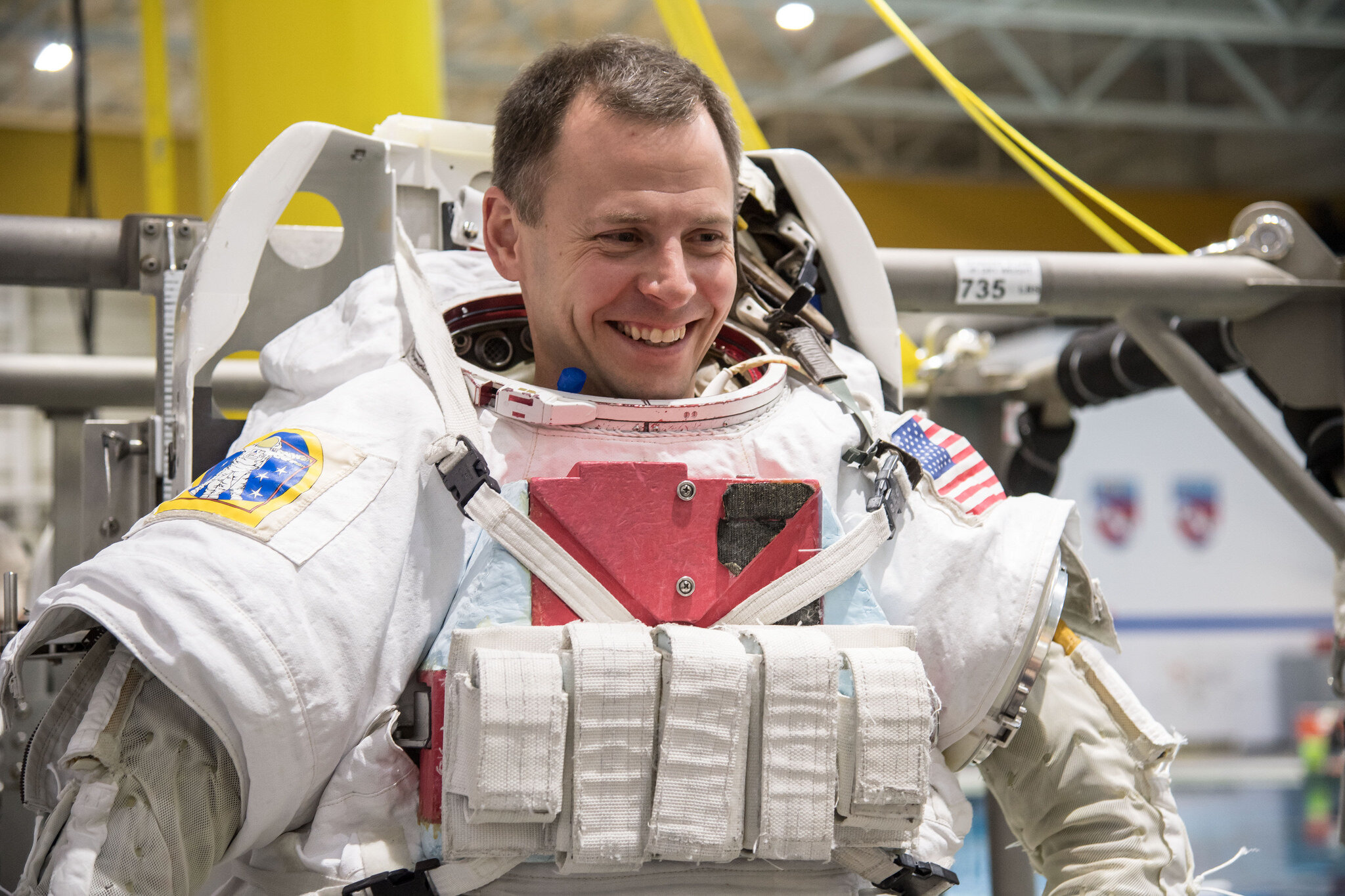 NASA astronaut Nick Hague smiles in his space suit during spacewalk training at NASA’s Neutral Buoyancy Laboratory.