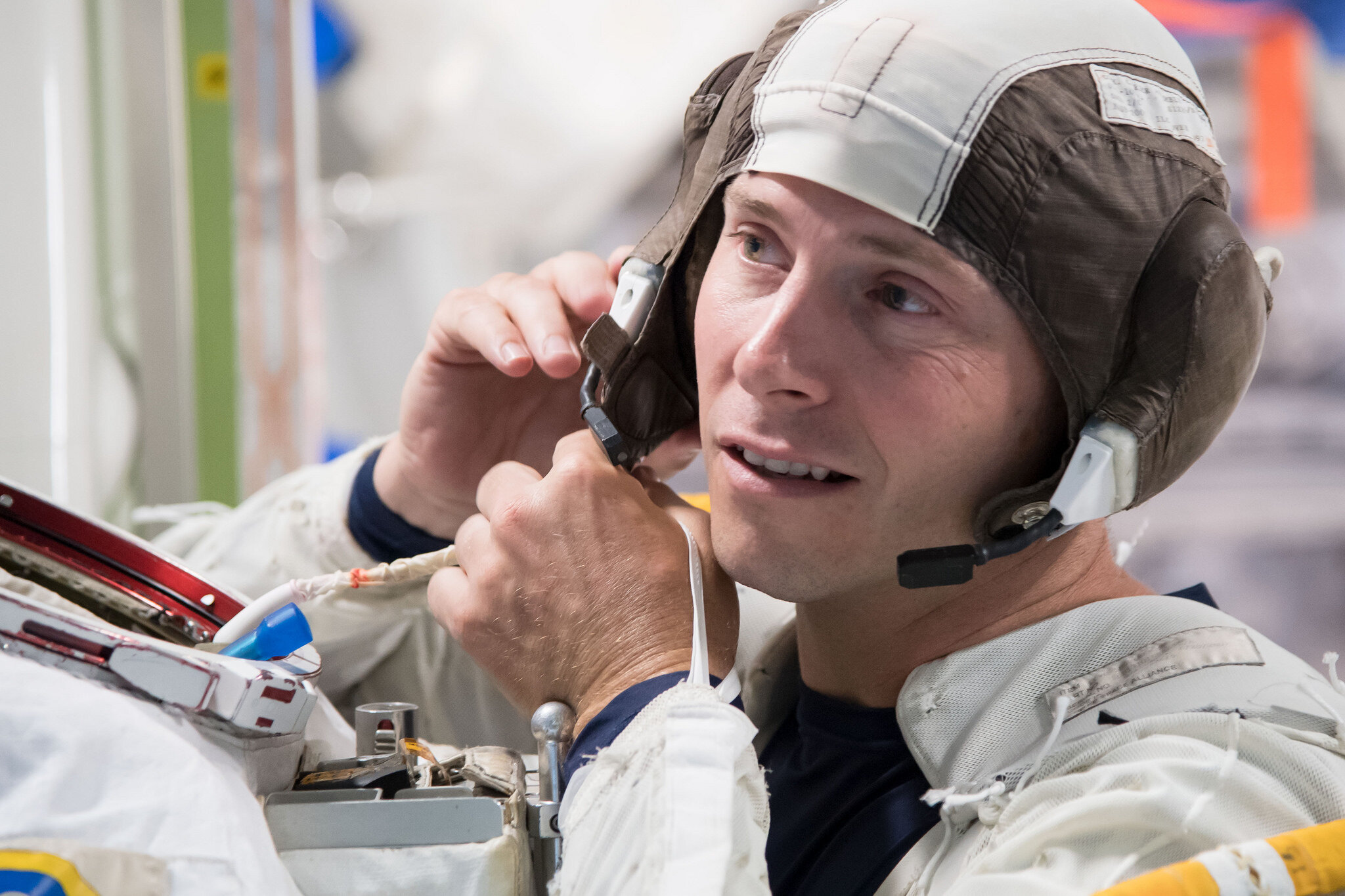 Nick Hague fastens his communications cap during training. 