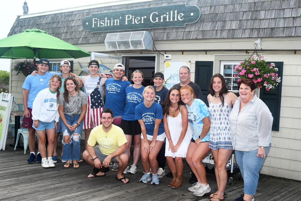 Holdyn with the crew of The Fishing Pier Grille.