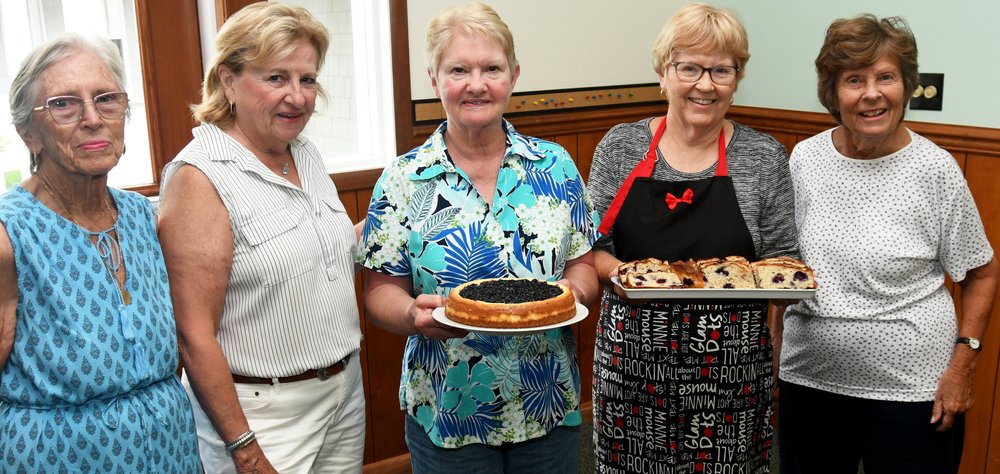 Volunteers posing with a blueberry cheesecake at Our Saviour Lutheran Church’s Blueberry Festival on July 17 are (from left): Maggie Crisman, Rose Divney,  Sue Farley, Diane Young, and Bonnie Kratzer.