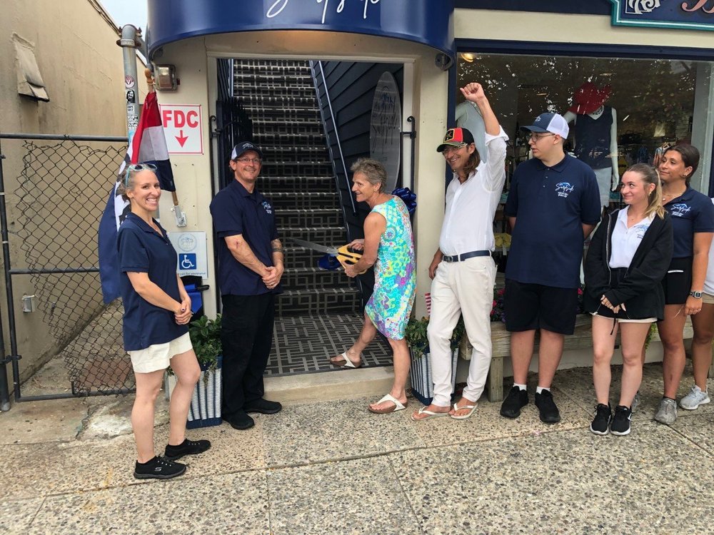 Stone Harbor Mayor Judith Davies-Dunhour performs the ribbon-cutting for Surfside  Grille on 96th Street, with Councilman Charles Krafczek and restaurant staff on hand.