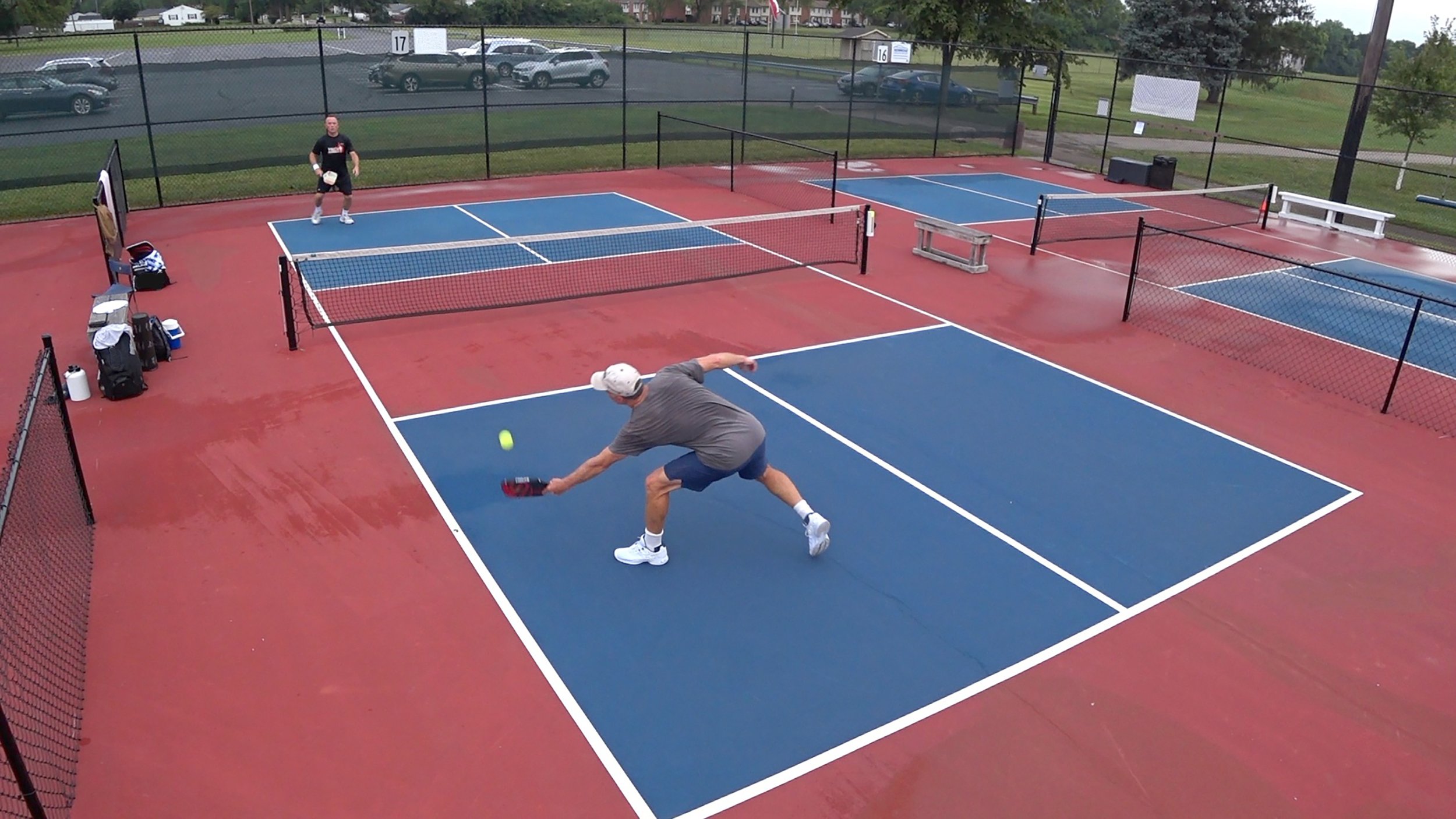 Pickleball players engaged in a singles match. 