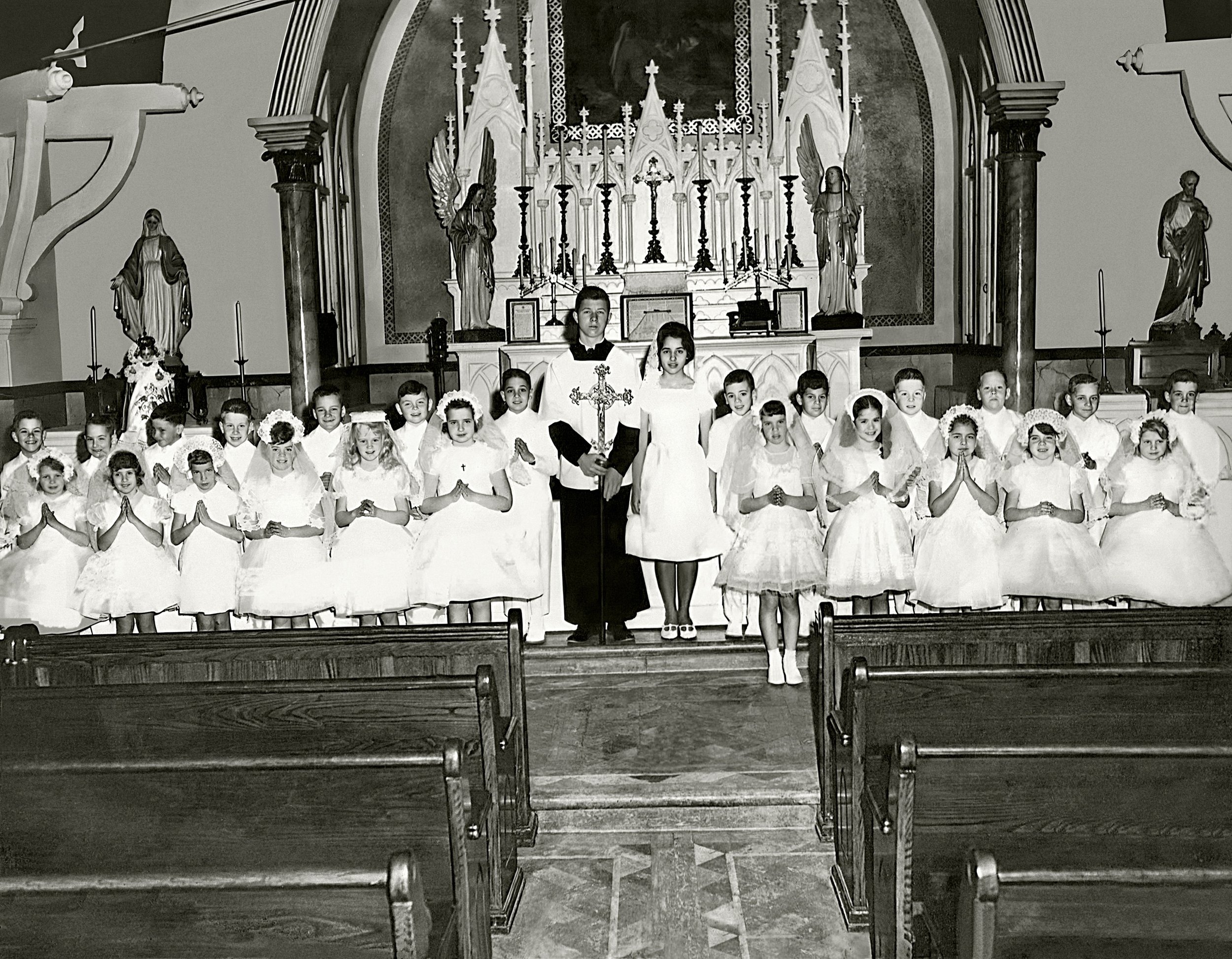 First Holy Communion Ceremony in 1966. The “Christ on the Cross” painting hangs above the altar before it was taken down.