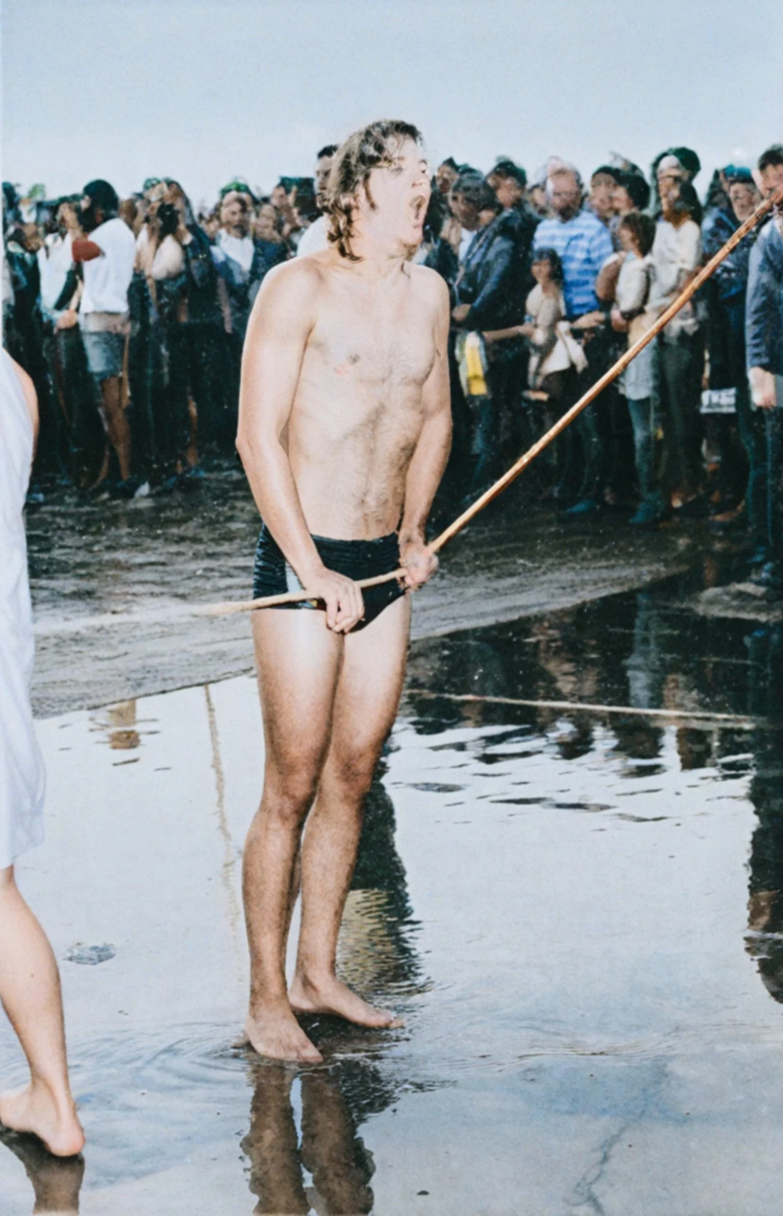 Tim McKee screams as he touches the finish rope for the 1973 swim championship.