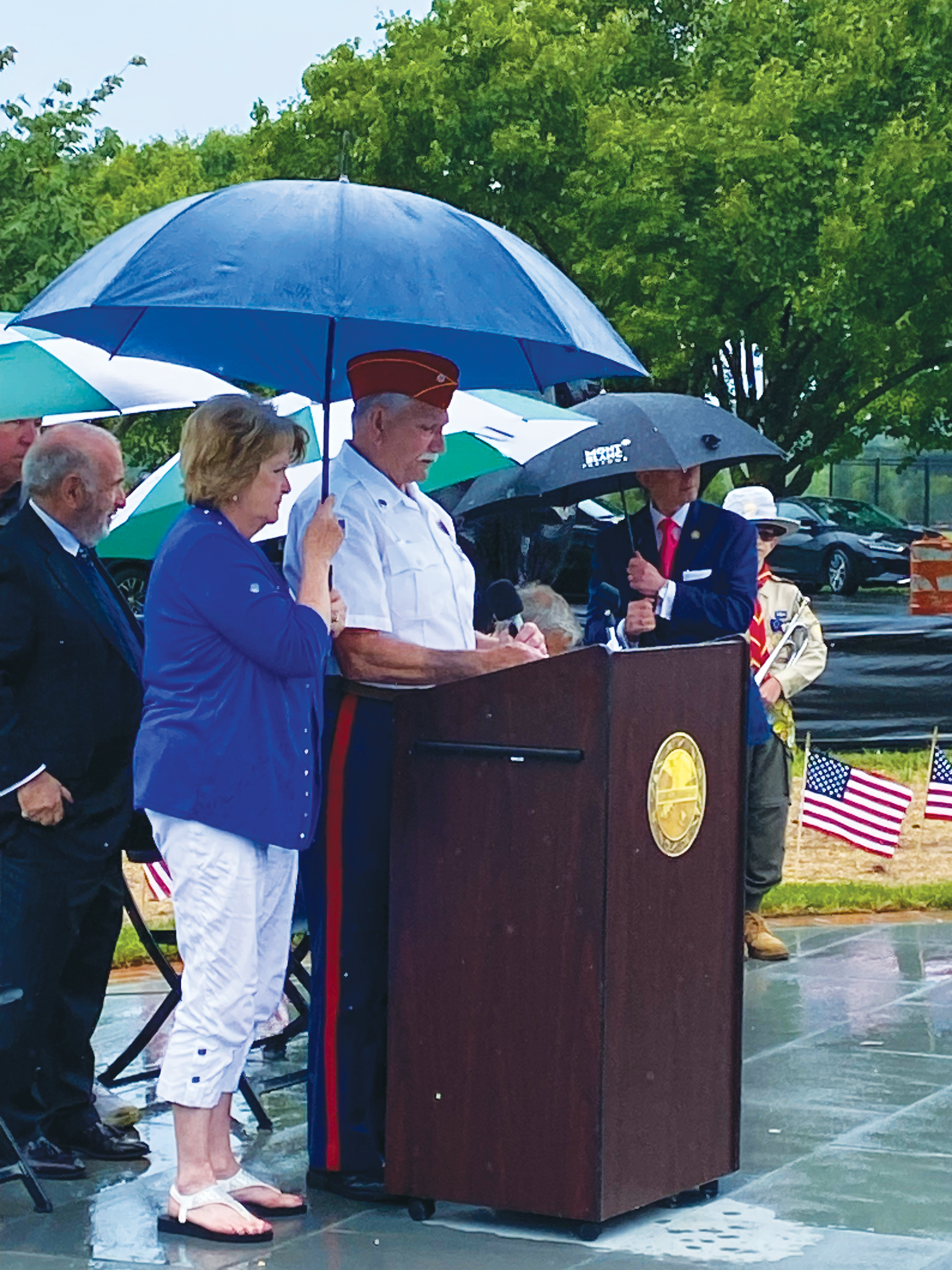 LaRosa’s wife Sharon holds an umbrella keep him dry during his 2024 speech at the Cape May Veterans Cemetery.