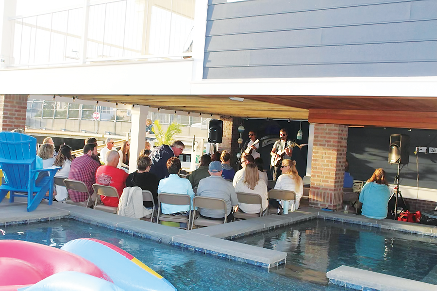 Peter Mayer performing his own  music for a group of friends.