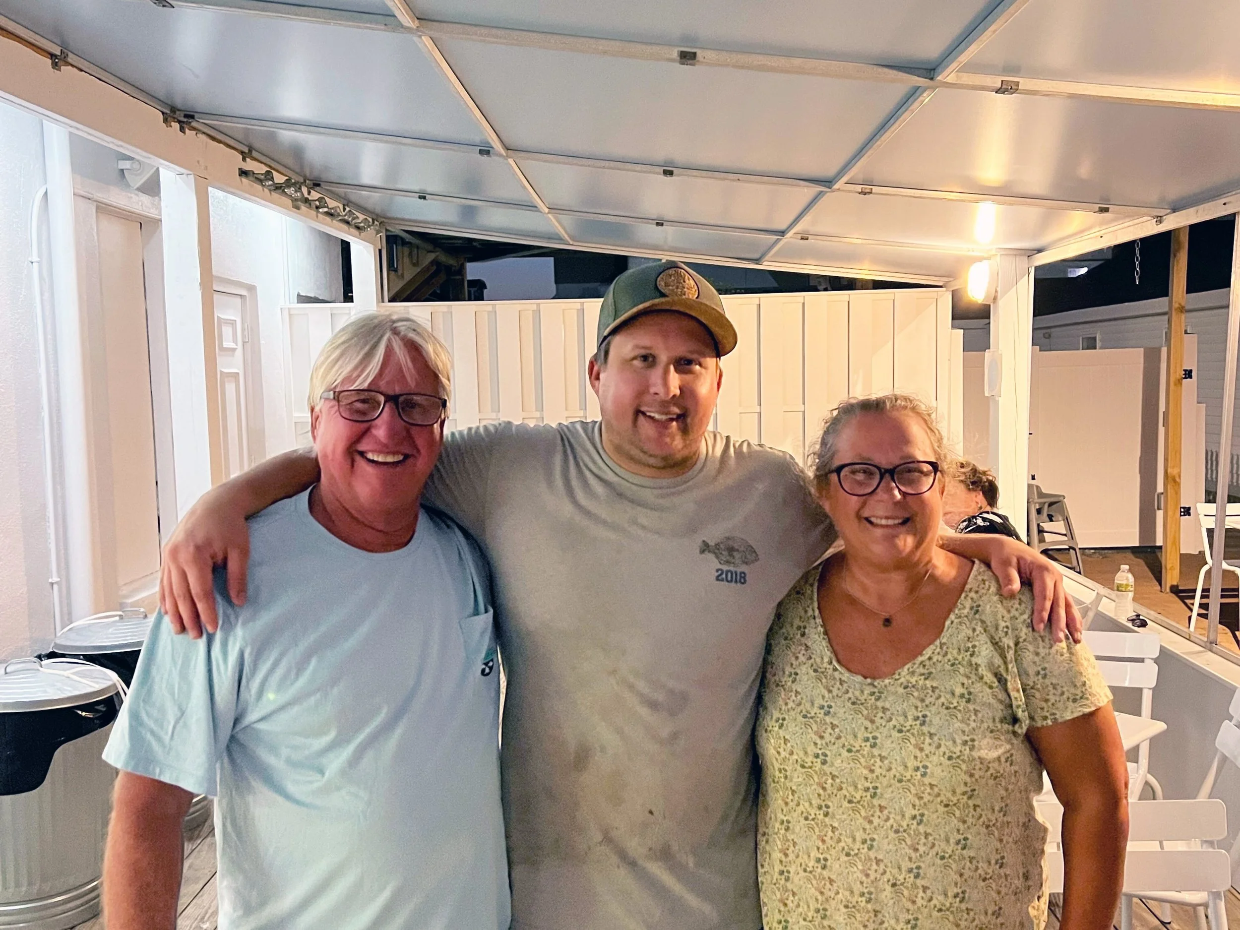 Paul (center) celebrating his birthday on the  patio with his parents, John and Lisa.