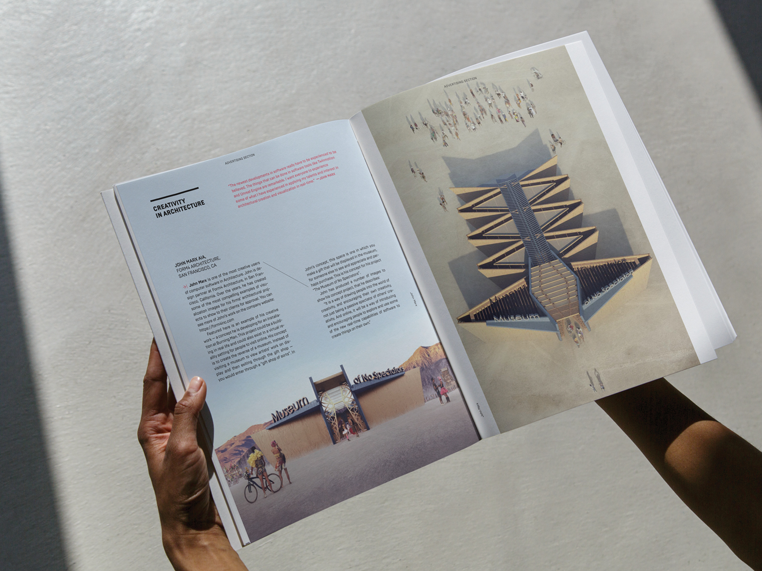  Picture of a man holding opening a magazine with a front and overhead renderings of the Museum of No Spectators from Burning Man. The headline at the top of the left page reads, Creativity in Architecture by John Marx, AIA. 